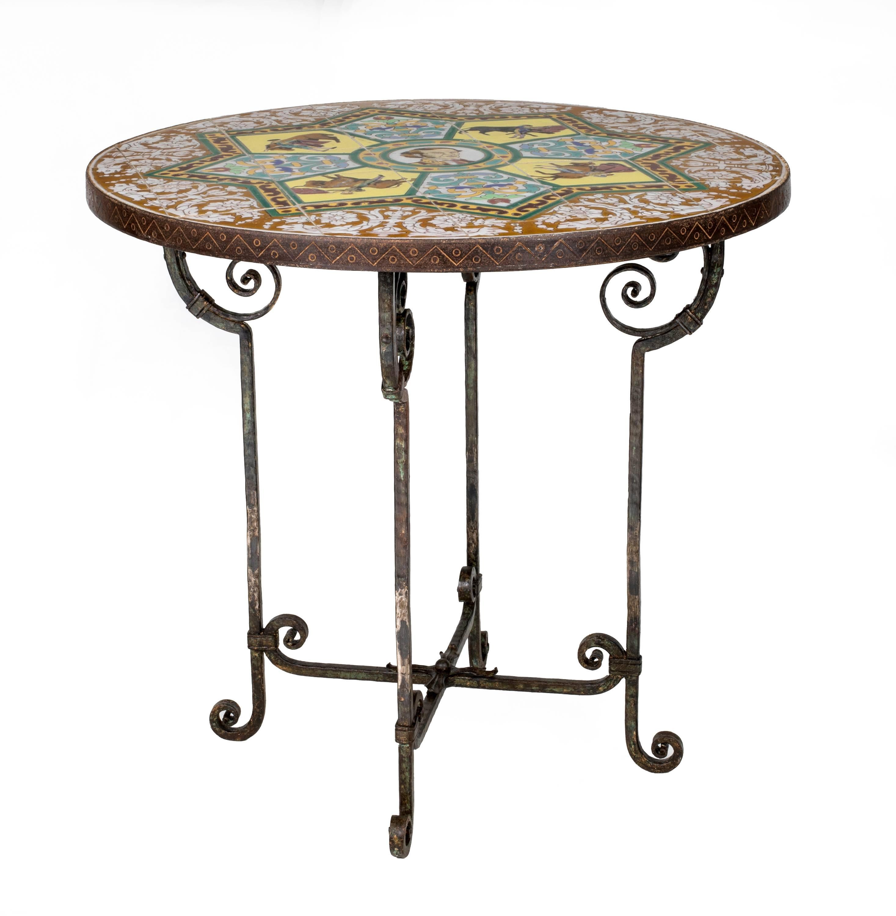 Vintage 1930s Spanish Revival tiled round table. Very decorative, brightly colored tile top with Spanish bull fighter motif.   The tiled top is captured with iron trim and supported by hand-wrought iron base. Surface top could be enlarged with a