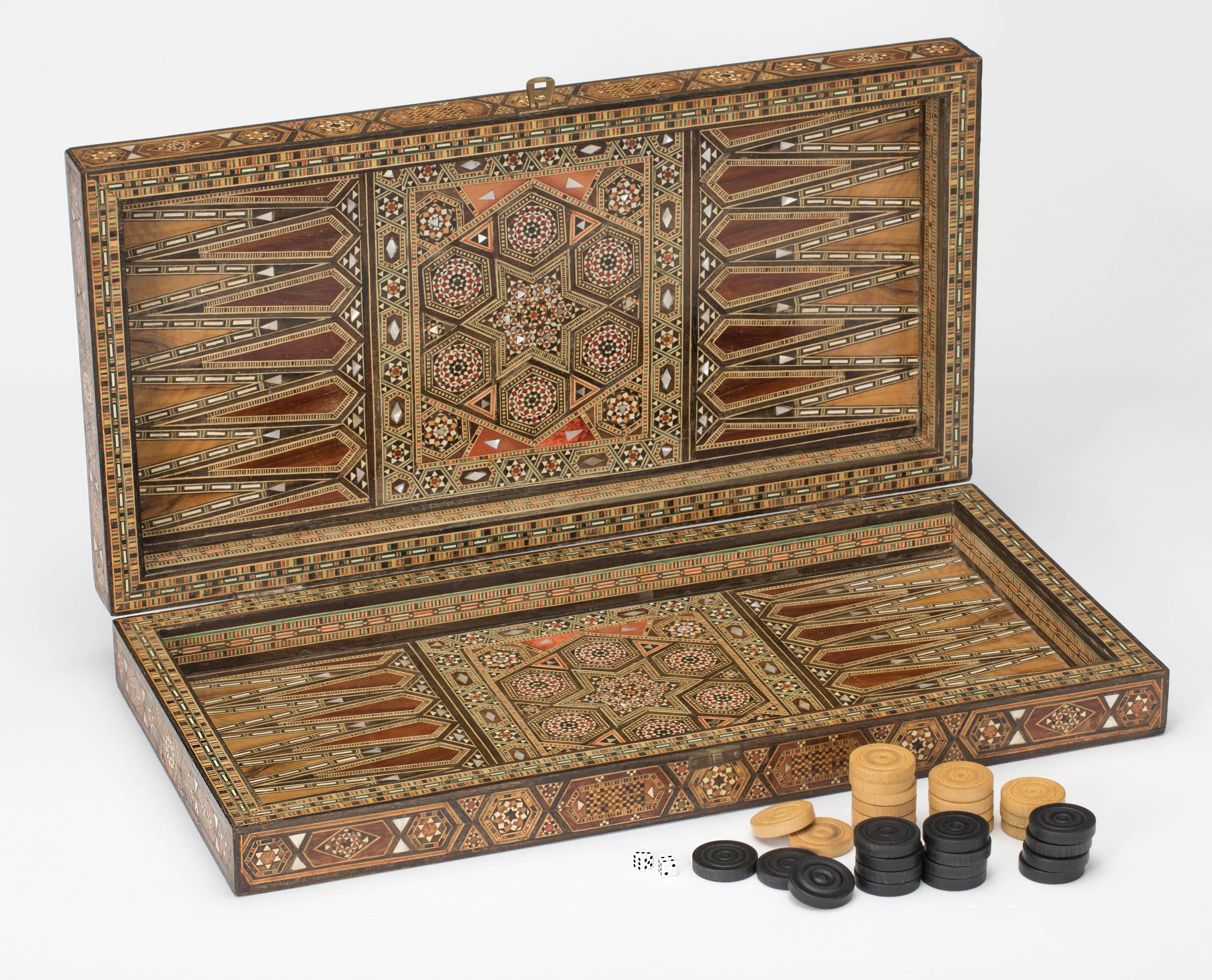 Backgammon board box in Intricate inlaid mosaic of various wood, mother-of-pearl and bone. Excellent condition. Complete with disks and dice.

Measures: 20 x 20 when open.
   