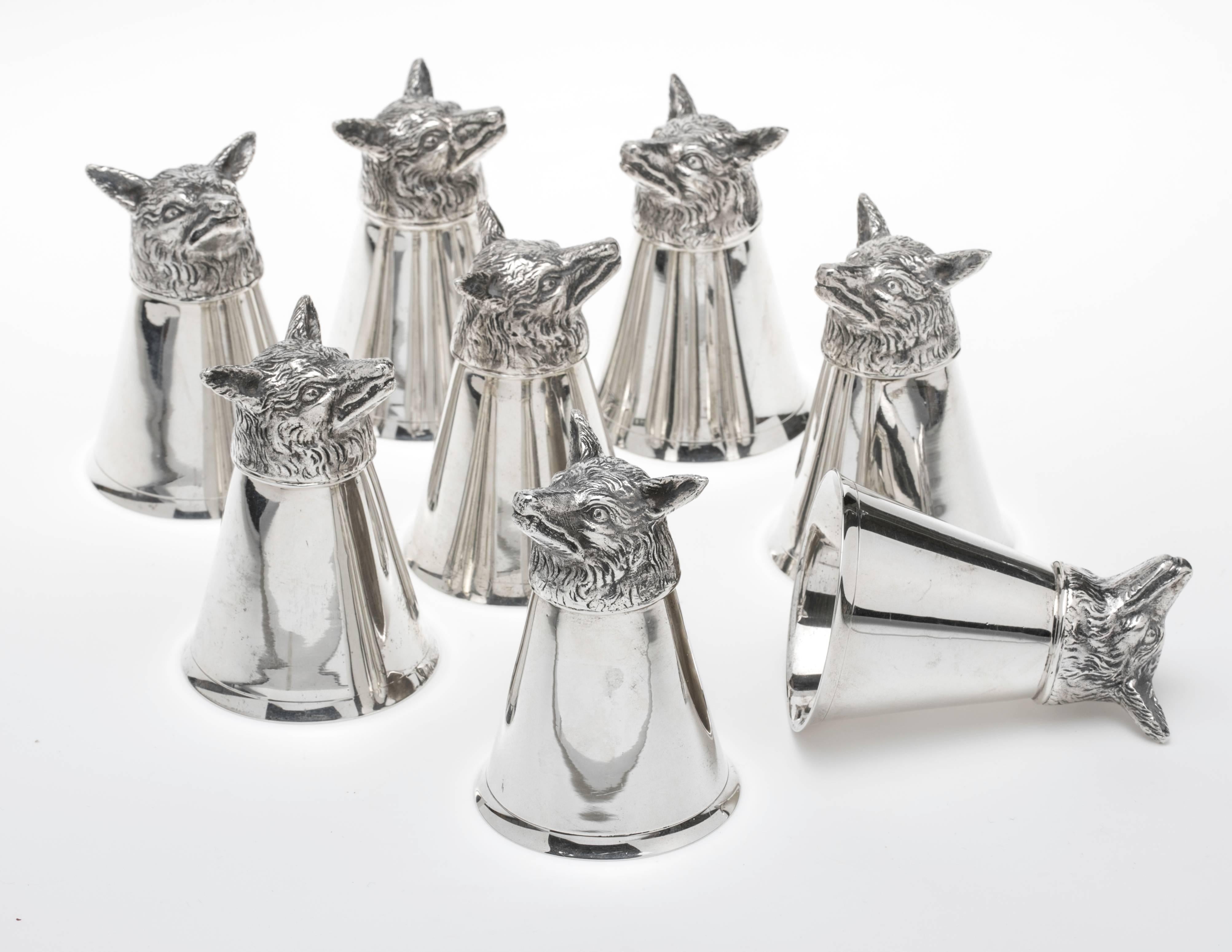 Hard to find, set of eight fox head sterling silver stirrup cups. In excellent condition. Hallmarked under the head.