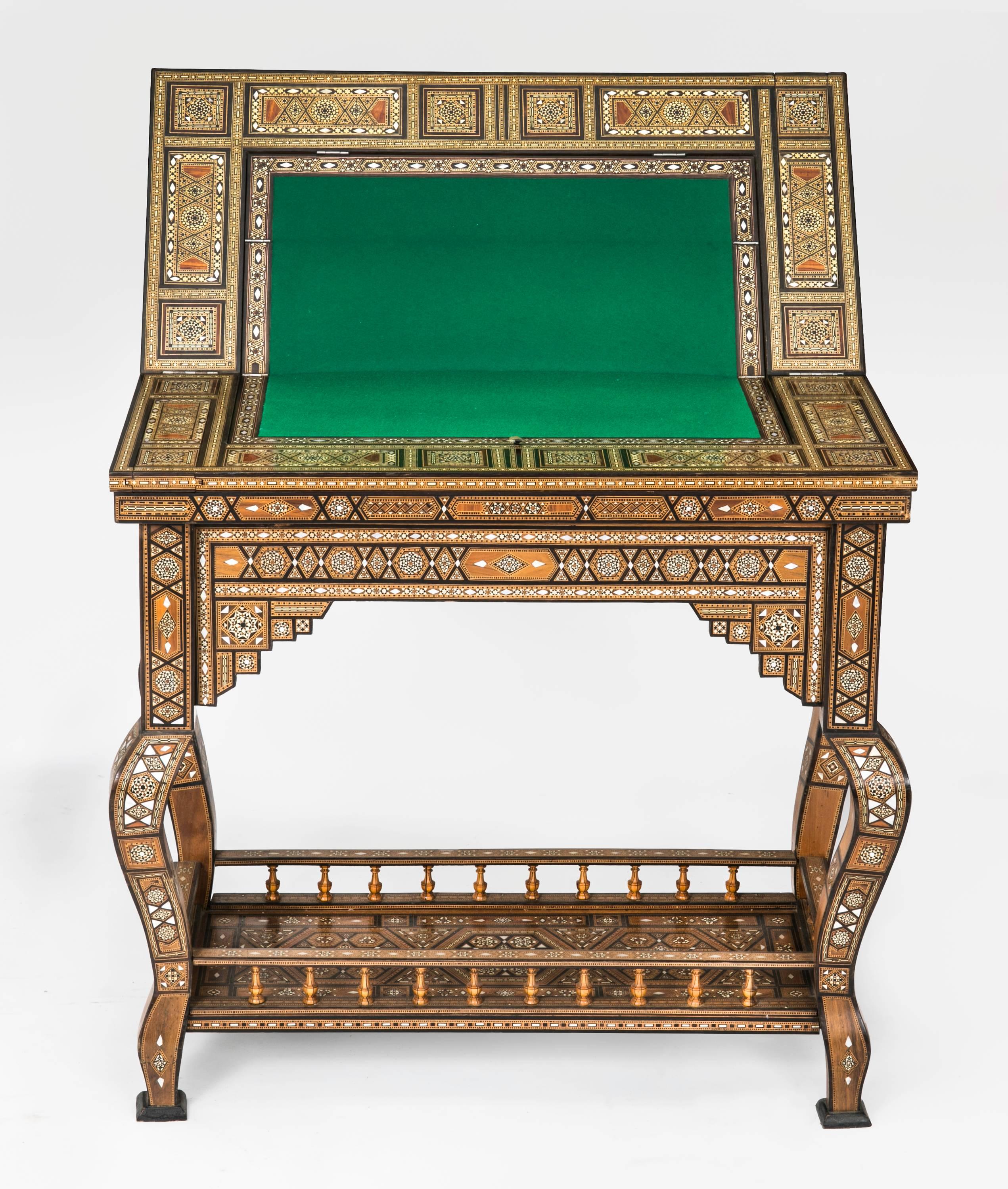 Early 1930s Syrian game table. Amazingly intricate and beautifully executed inlay work in various wood specimens, mother-of-Pearl  and bone. 
Tabletop folds open to newly covered felt for card game, folds open again to backgammon and chess board,