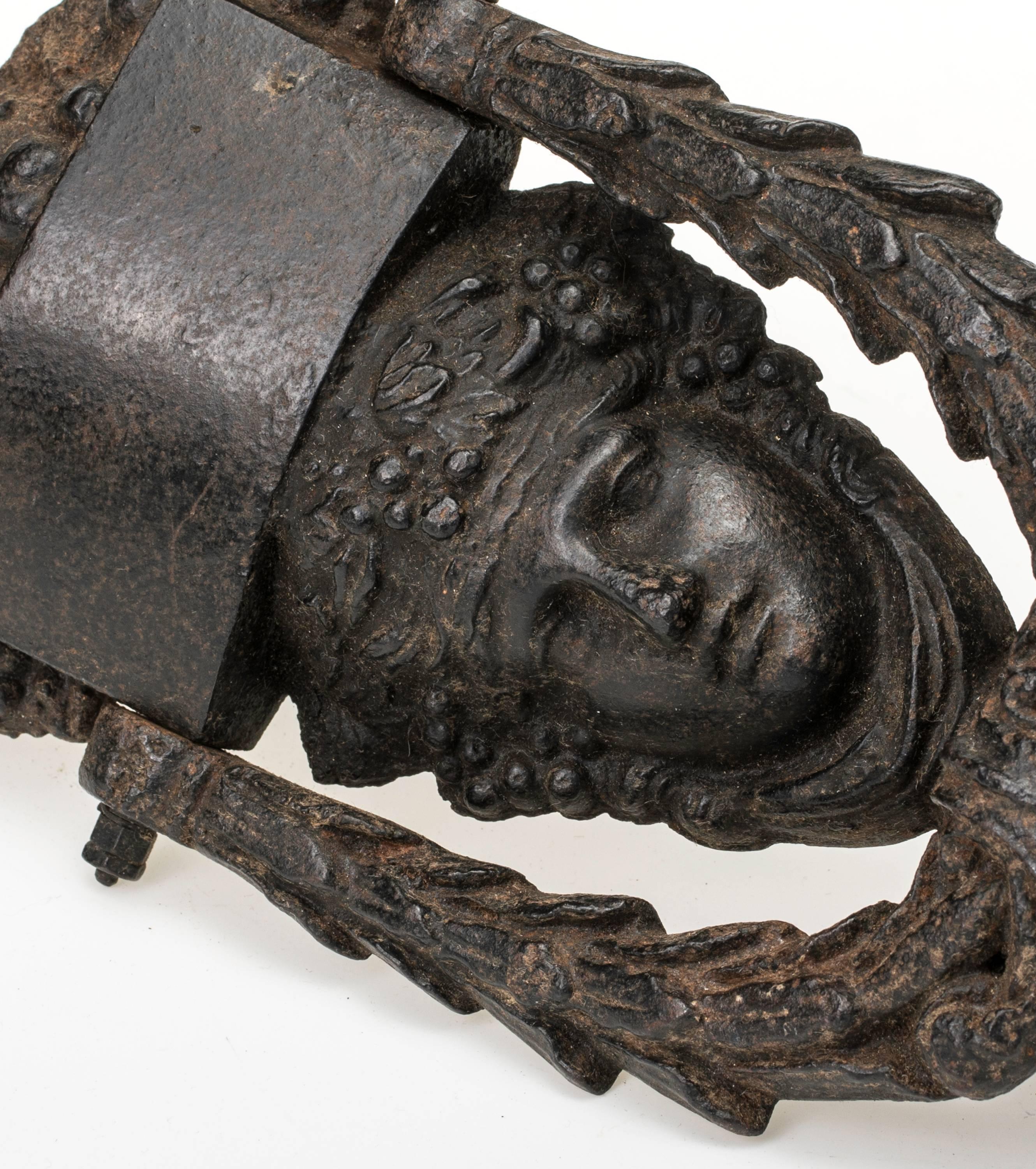 French iron door knocker featuring face of Athena adorned with florals wreath, circa 1900s.