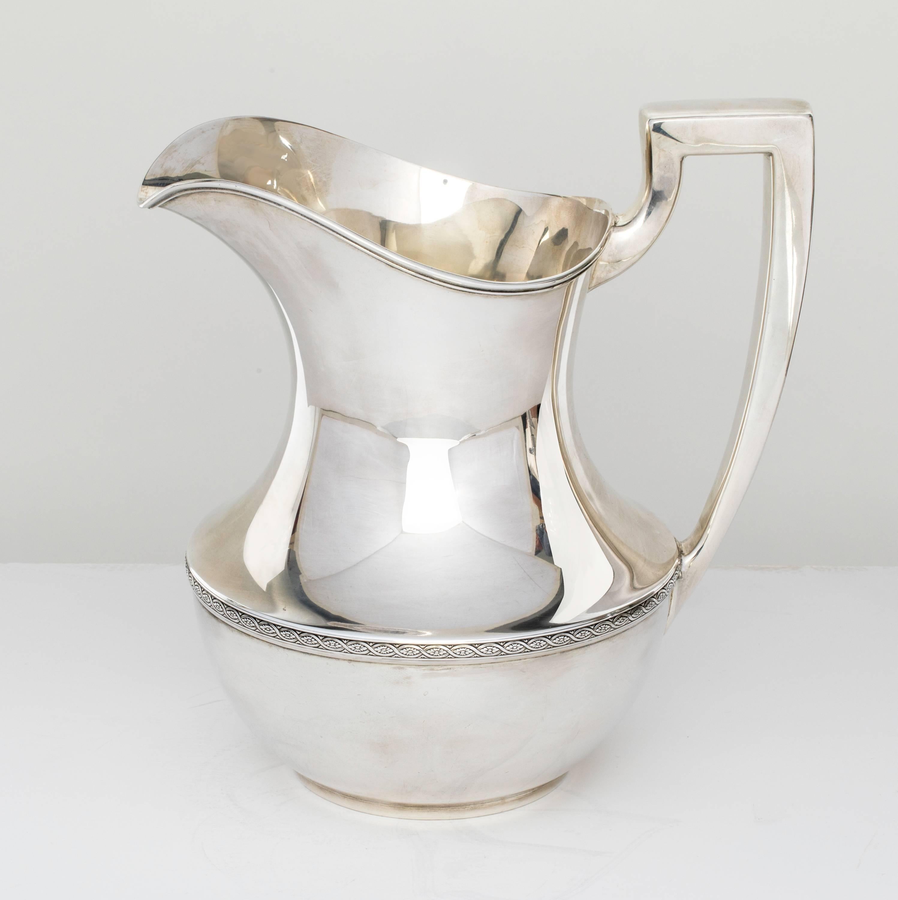 Weidlich of Bridgeport Connecticut, circa 1930s sterling silver water pitcher. Beautiful and simply shaped body with squared handle.
In excellent condition.