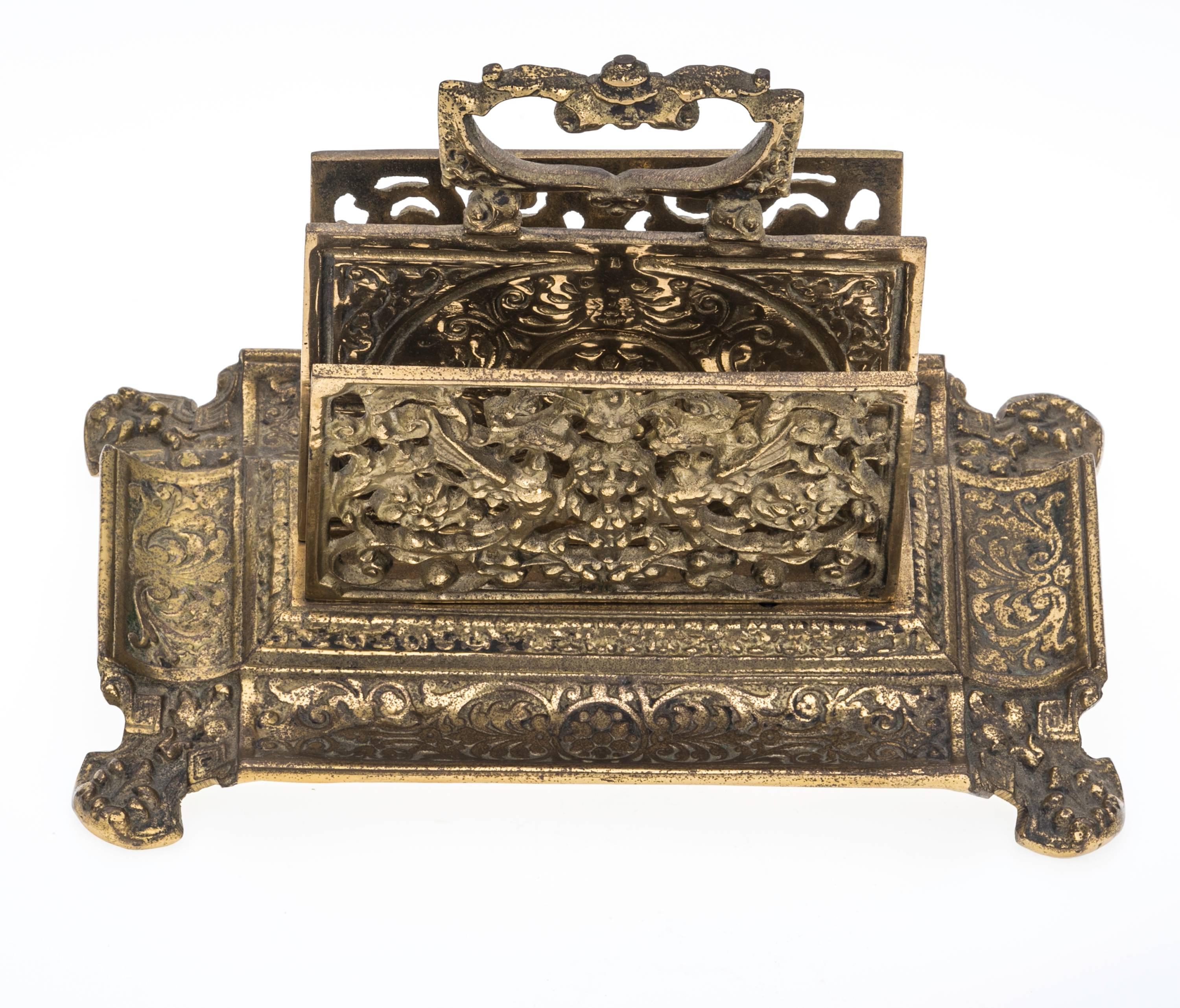 French antique brass letter holder. Beautiful panels of cast brass with divided compartments for letters, ample handle in the mid section. Each sides have pen wells. Wonderful addition for your desk.