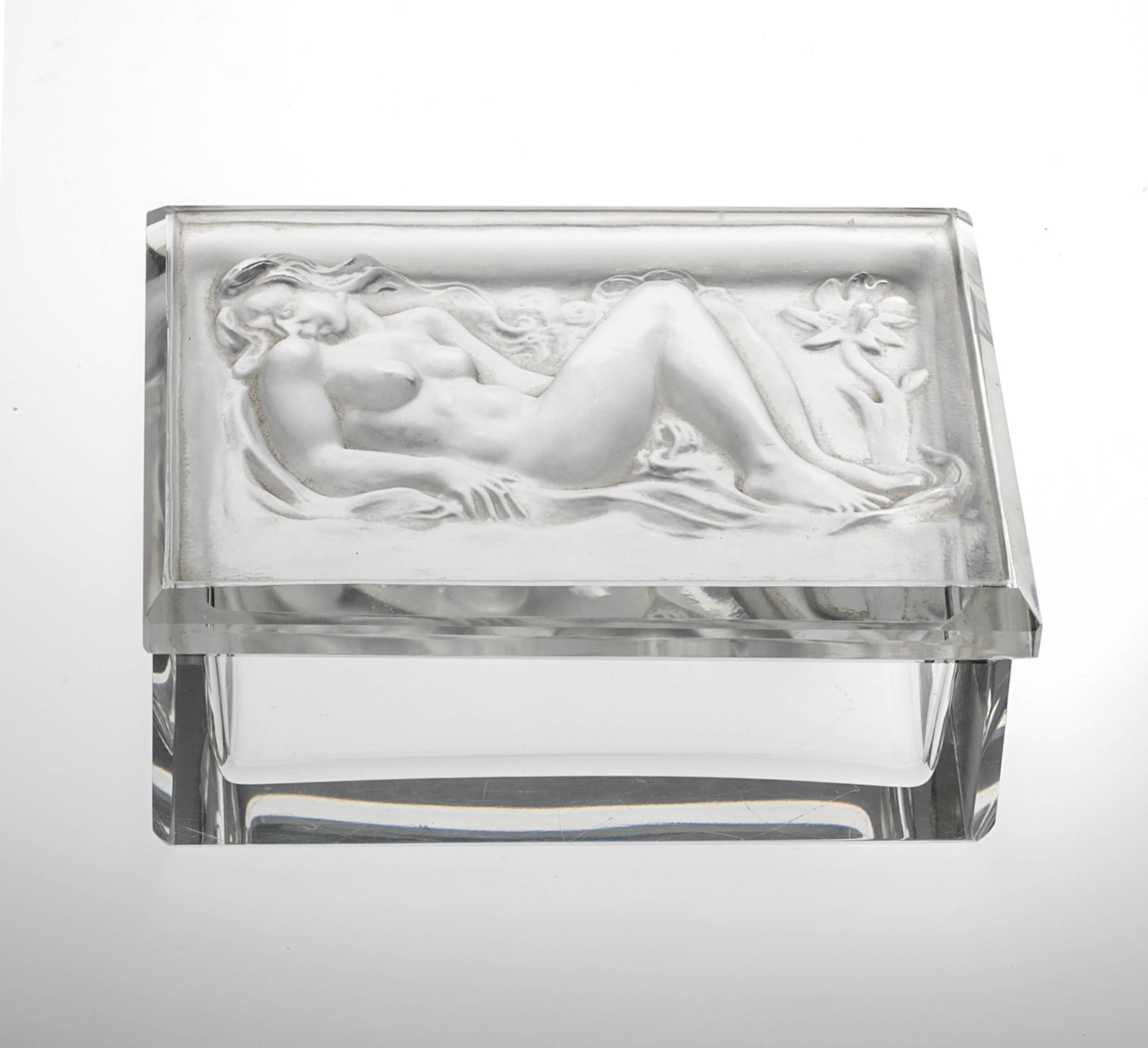 Beautiful two-piece crystal glass box. Lid is relief of reclining nude.