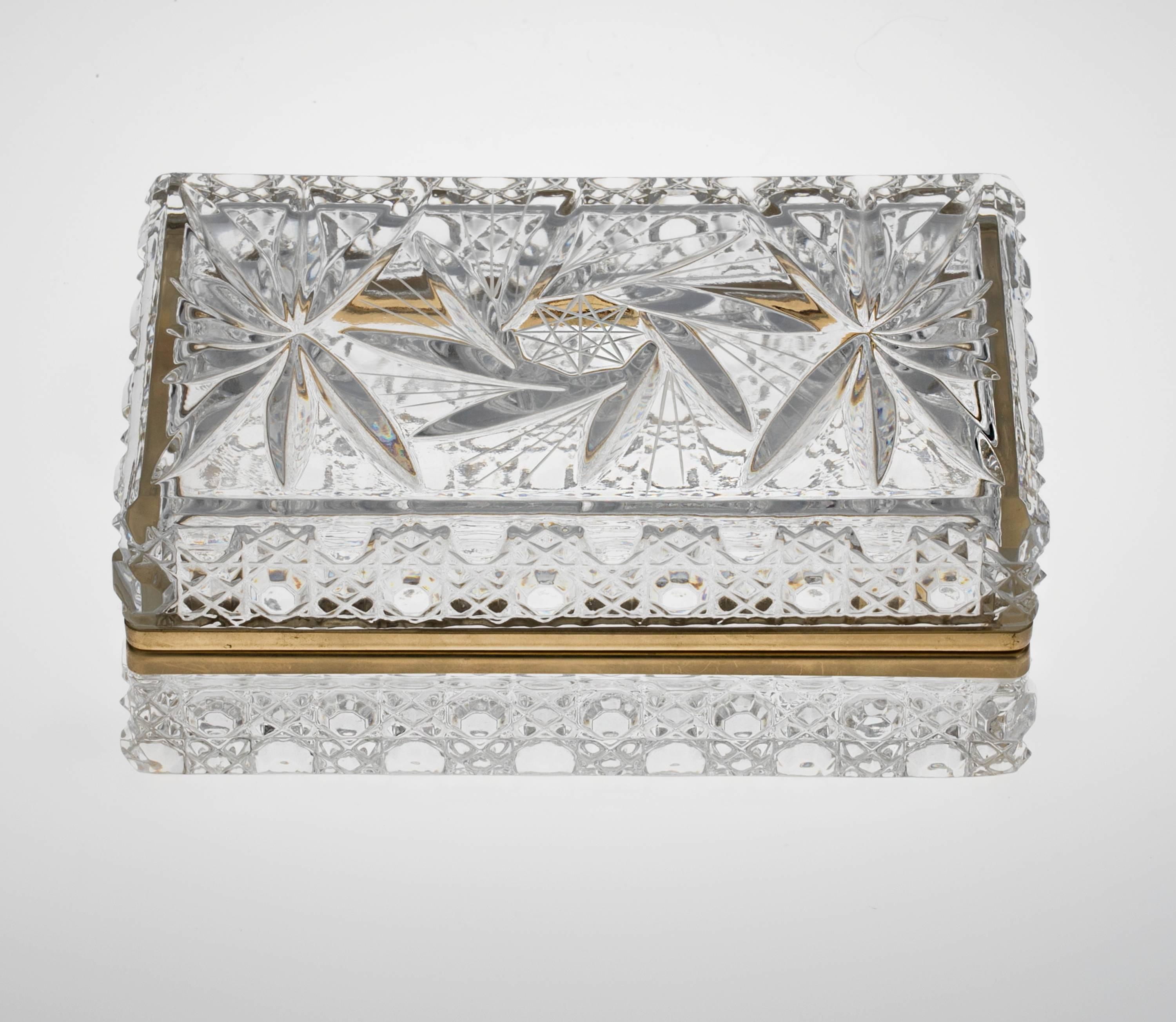 Beautiful cut crystal box with gilt bronze hinge mount. Top panel is cut fan shape flowers and base is well cut diamond panels.
Elegant lovely addition to your dressing table.