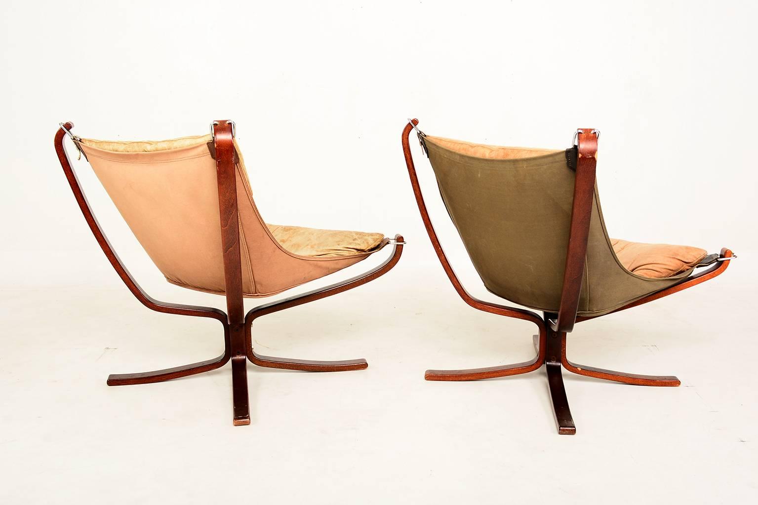 For your consideration a pair of Falcon chairs and matching ottoman by Sigurd Resell. 

Leather and canvas are sun faded giving them a unique vintage character. 

Some of the saddle leather straps have been replaced with new saddle leather.