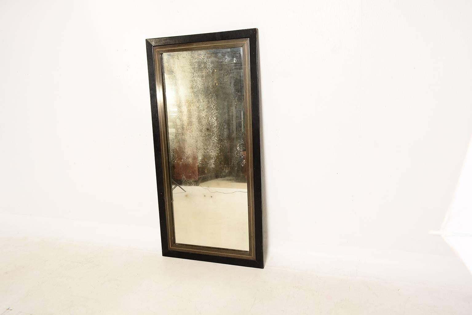 For your consideration a vintage wall hanging mirror wrapped in leather. Mahogany wood with brass accent inserts. 

Original mirror has vintage oxidation which gives a great character. 
