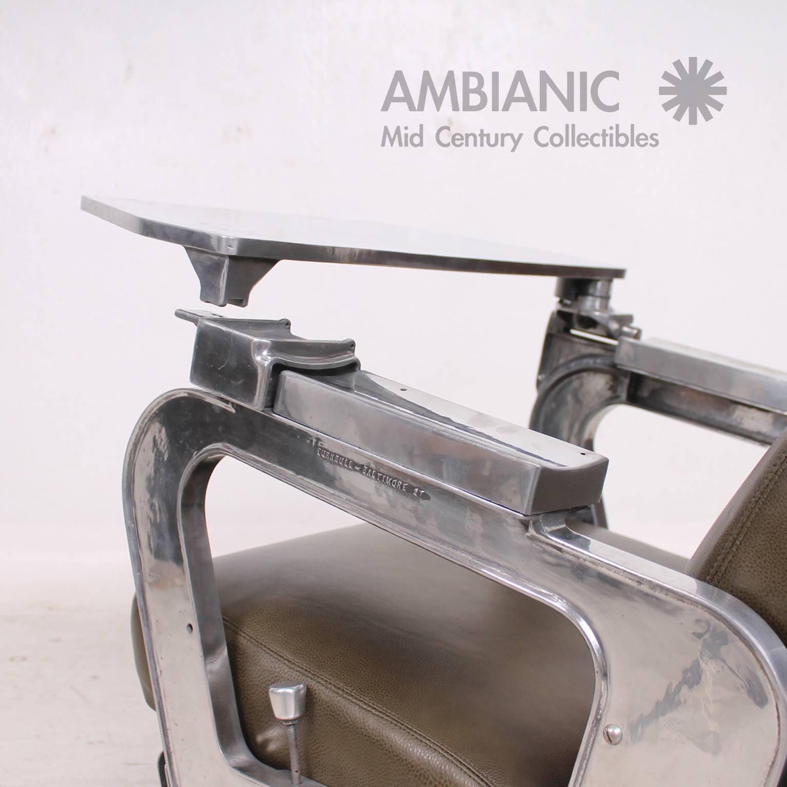 For your consideration a Mid-Century period airplane chair made of polished aluminum and new olive green leather. 

The chair has an unusual Industrial look mix with air of the air deco period. 
The Italian leather is soft and it has a beautiful