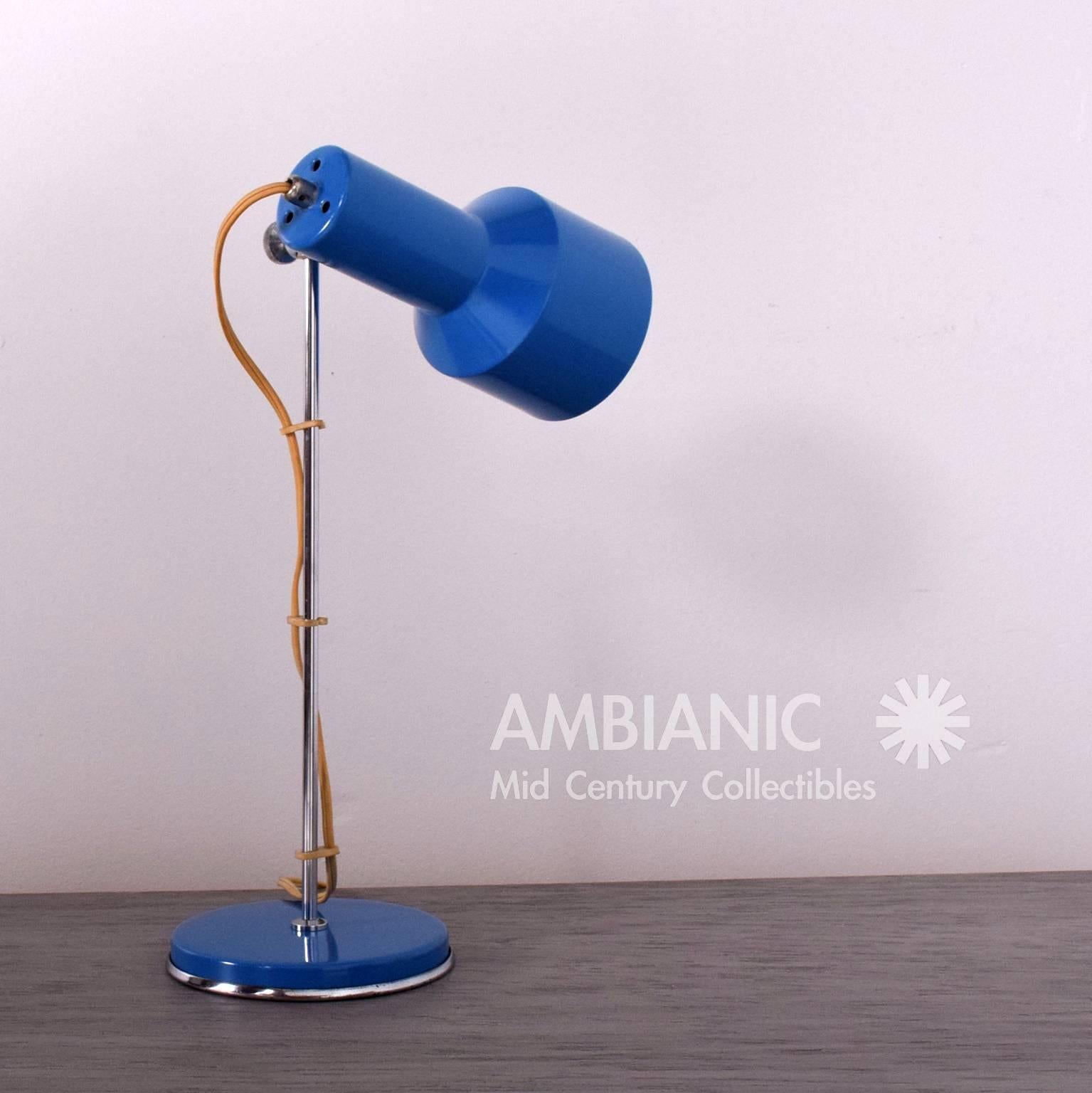 For your consideration a pair of Mid-Century Modern table lamps with adjustable shades. 

The shade can be positioned in almost any desired position. 
Lamps have the original chrome-plated finish. The lamps have been restored in medium blue