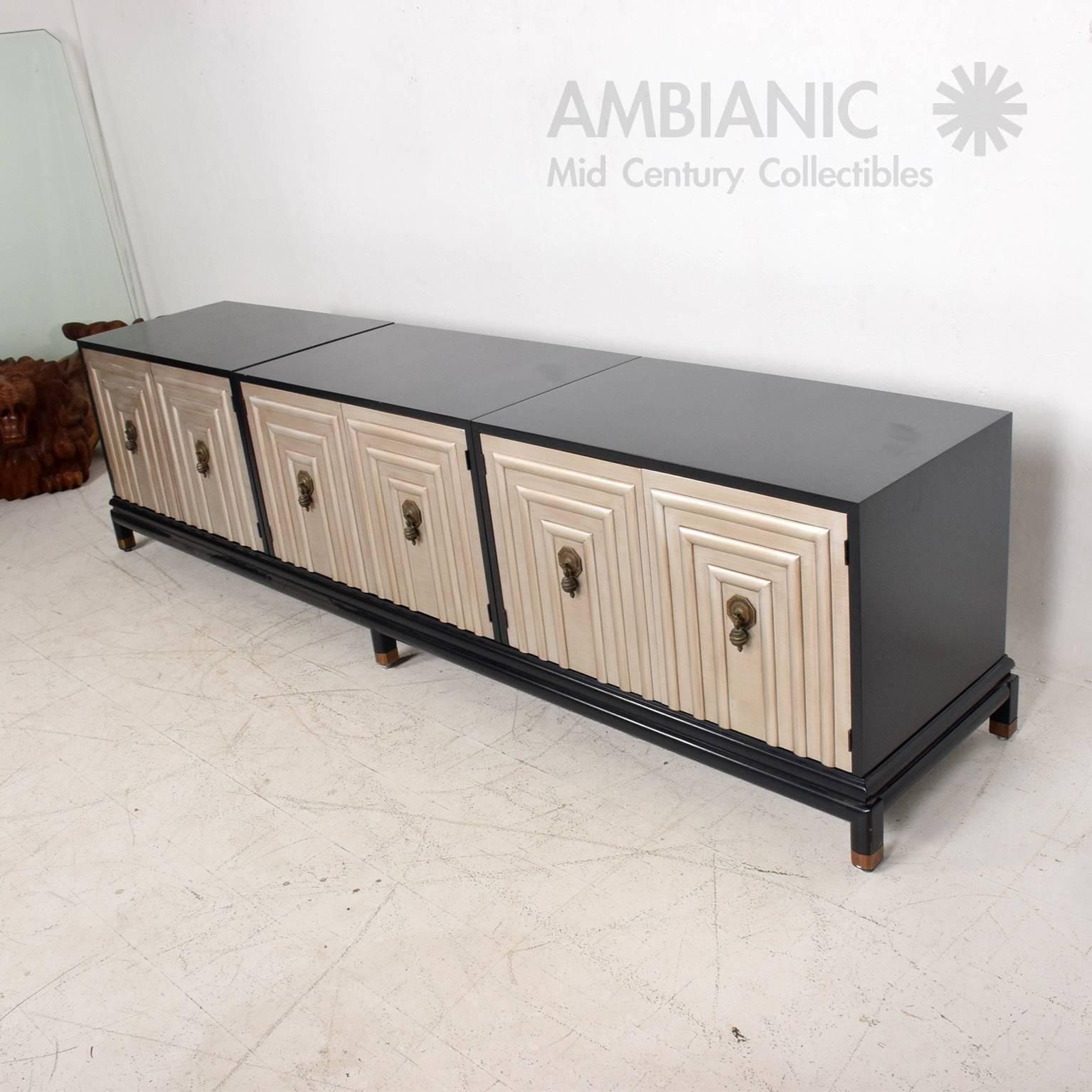 For your consideration a vintage credenza by Renzo Rutili.
Cabinets and base finished with a navy blue color. Doors have a silver finish with original bronze pulls (vintage original patina). All doors are firm and sturdy, open and close with ease.