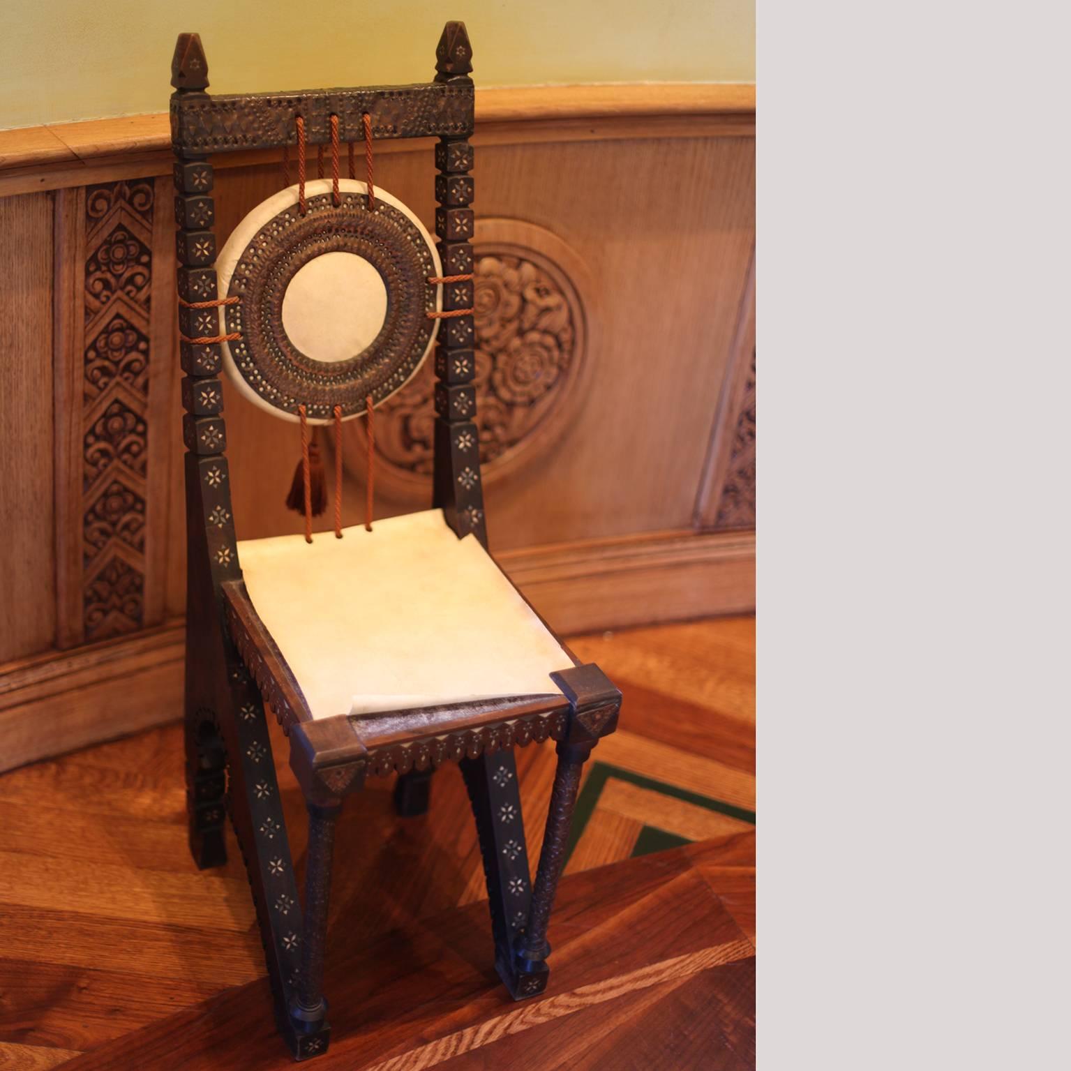 We are pleased to offer for your consideration a side chair by Carlo Bugatti.
Chair is in the original unrestored condition. 
The chair is beautifully decorated. Please notice the goatskin parchment is lifted from the seat.
Expect gentle vintage