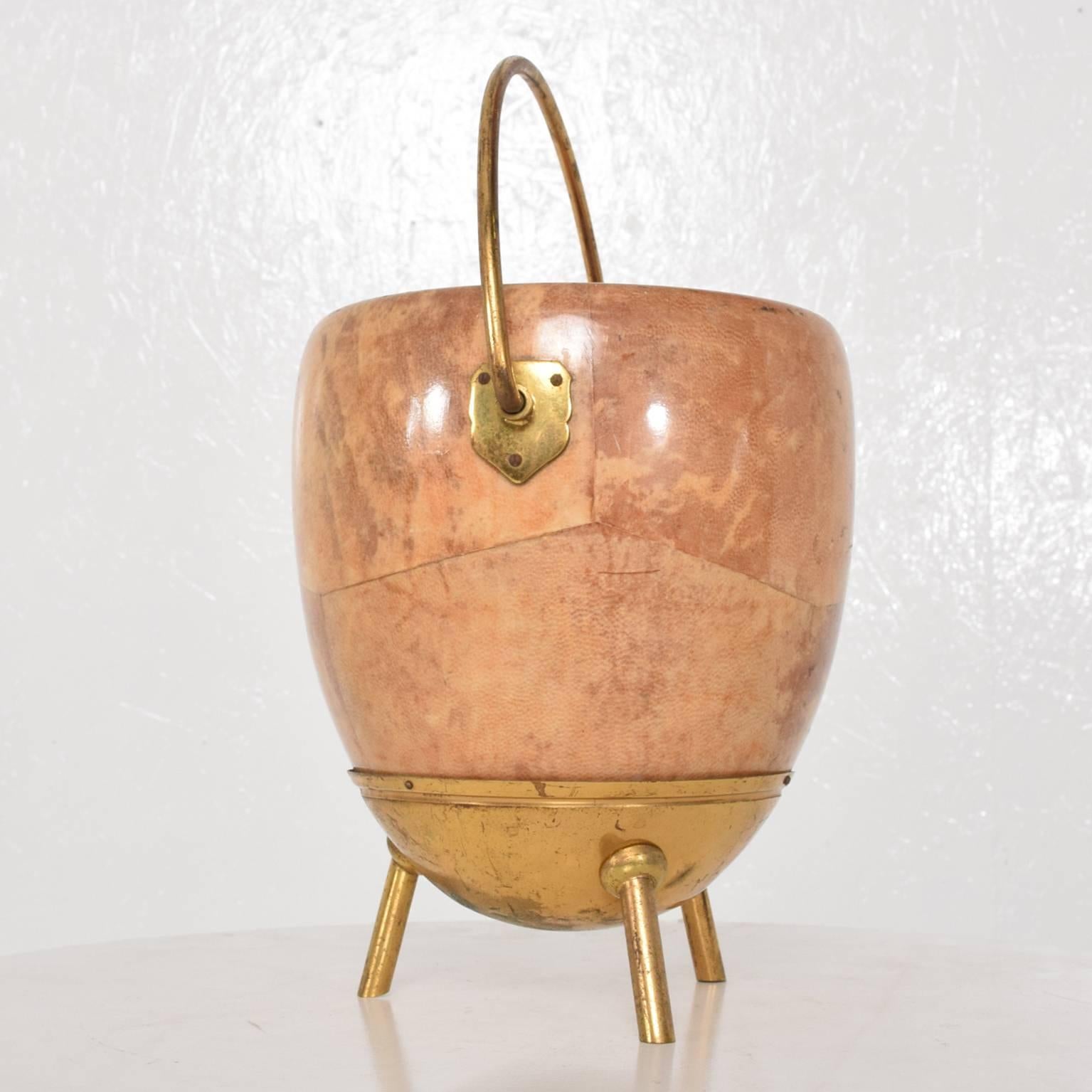 For your consideration a bucket after Aldo Tura (unmarked). 
Wood frame wrapped in goatskin leather and finished in tan color. Brass hardware. 
Missing mercury glass. Decorative item can be used as catch it all bucket. 
Italy, circa 1960s.