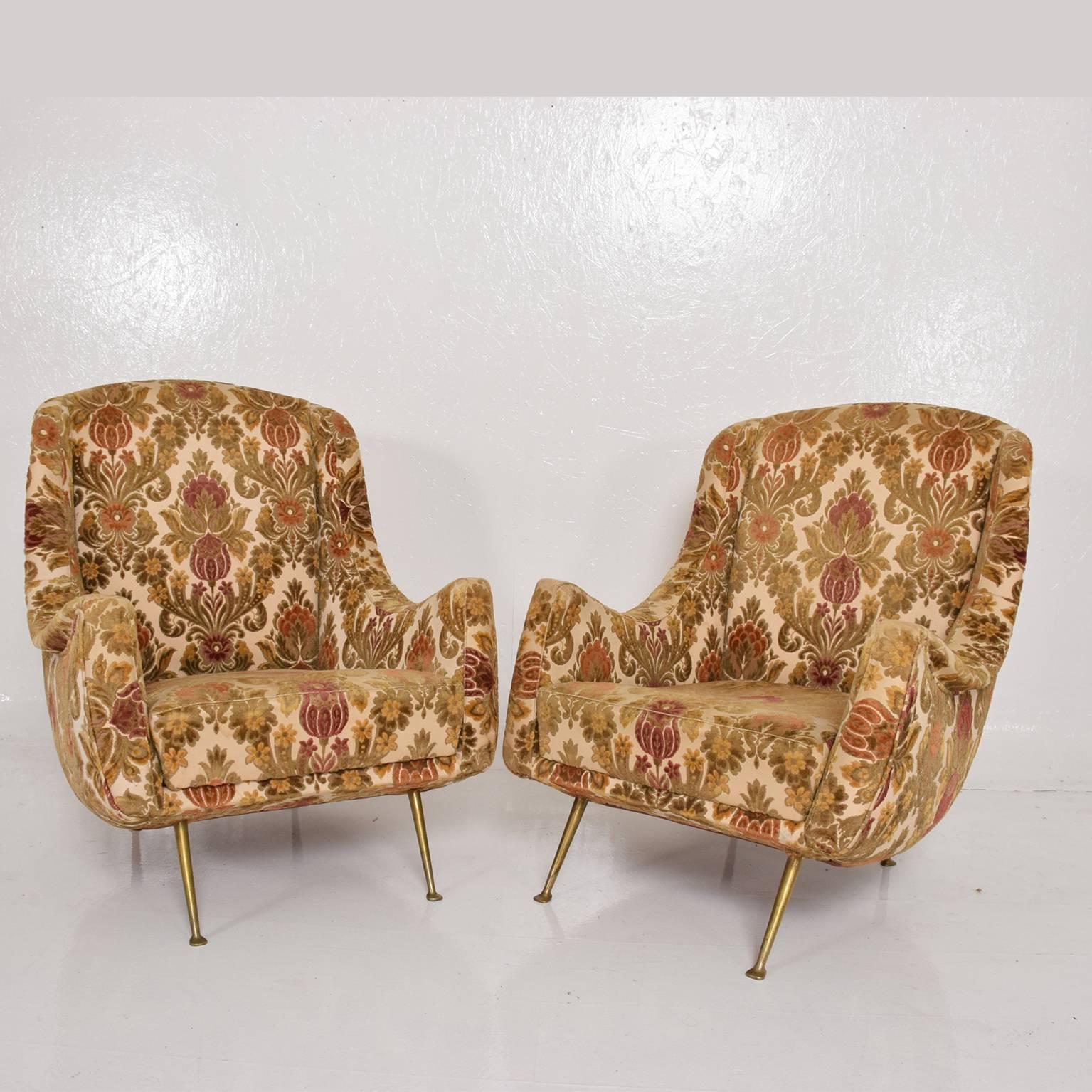 We are please to offer for your consideration a pair of sculptural armchairs. 
Original upholstery (has soem wear in the front corners of the arms). Sculptural brass legs. 

No label present form the maker. Made in Italy, circa