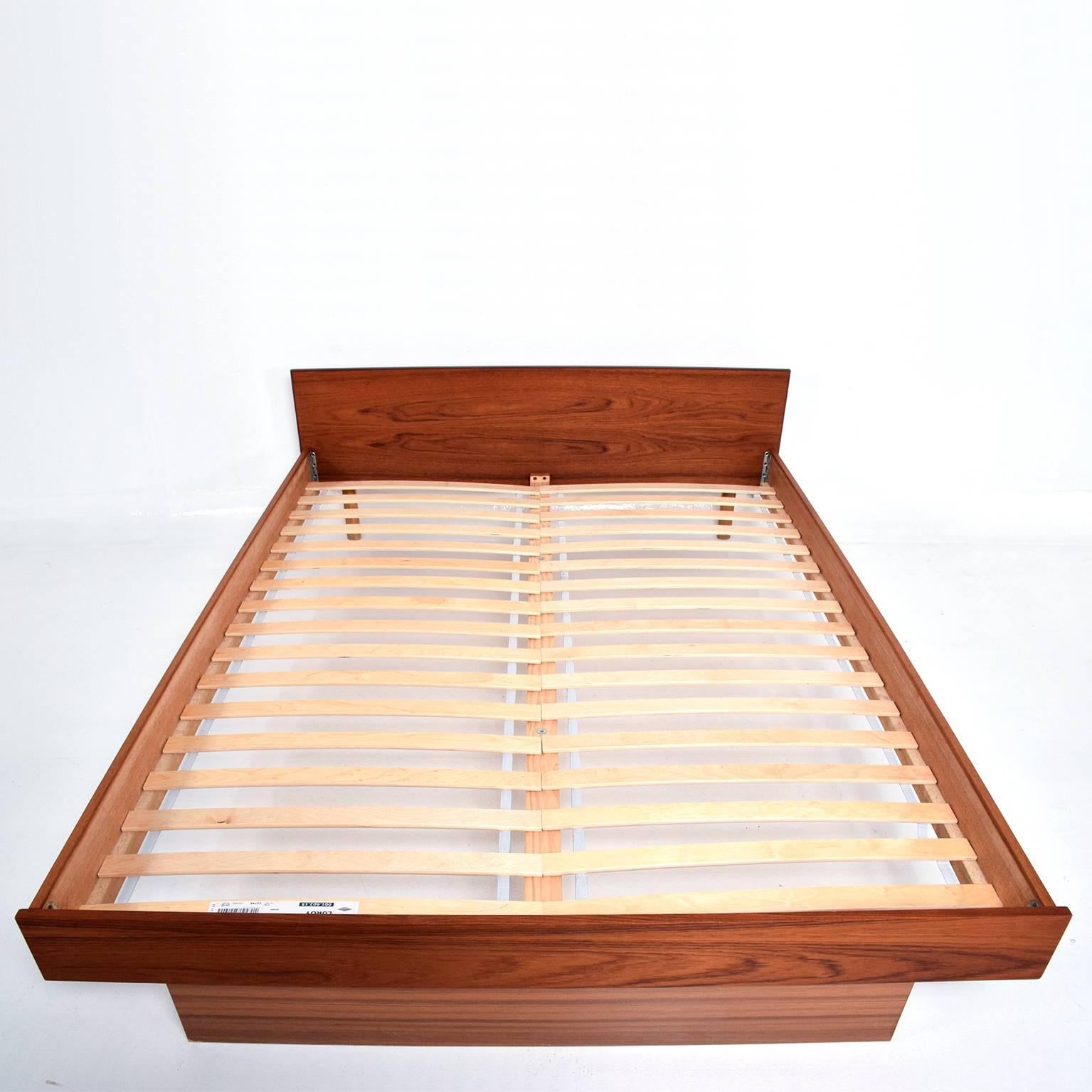 A Danish modern teak platform bed. Queen size. 
Unmarked, no label from the maker. 
Clean modern lines. 
Bed includes the wood slats. 
Dimensions: 23 3/4"H x 63" W x 81" D, Bed area 60 1/2" W.