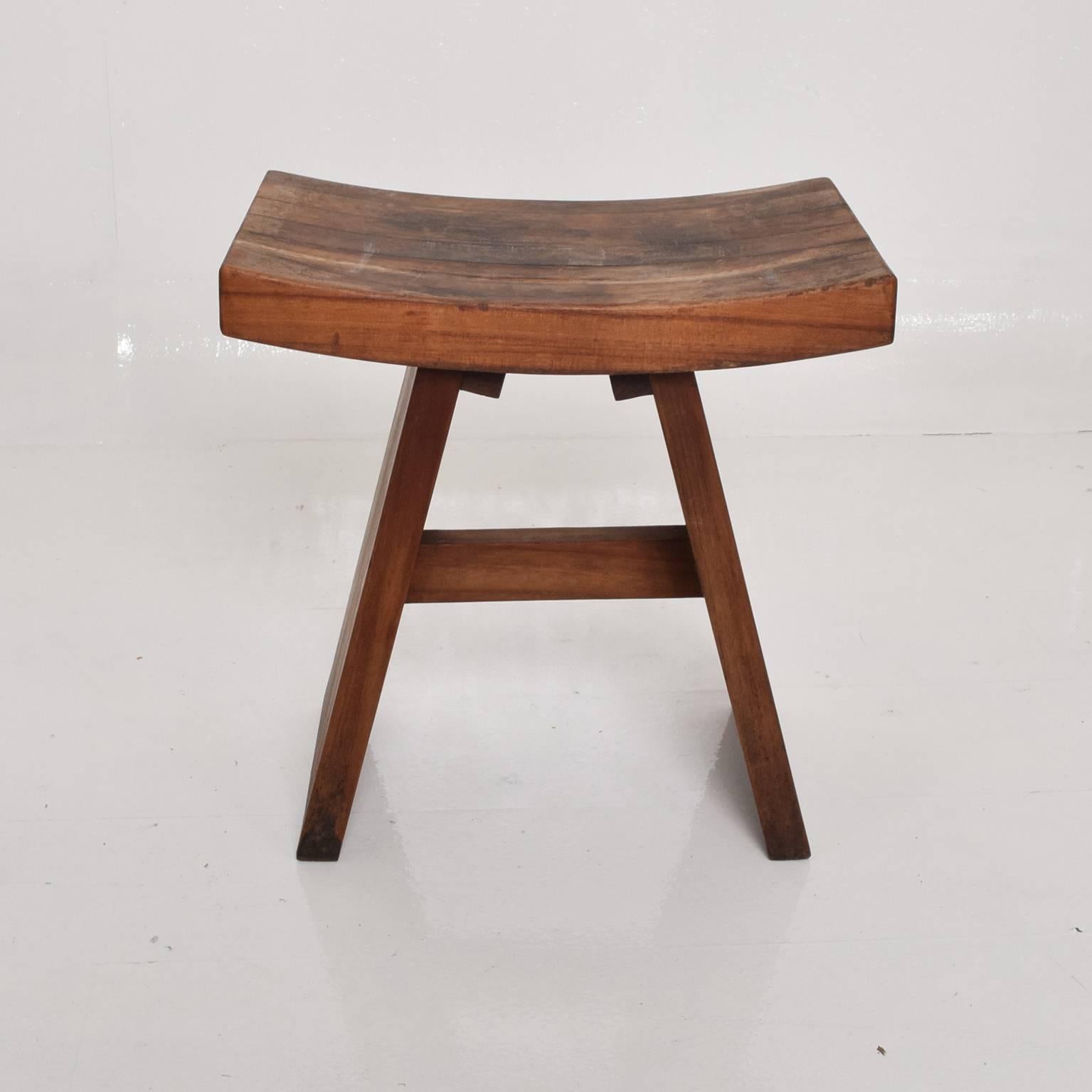 A custom stool in walnut. Unique construction. Sculptural shape. 
Unmarked, no information on the maker. 

Dimensions: 18 1/4" H x 18" W x 12"D