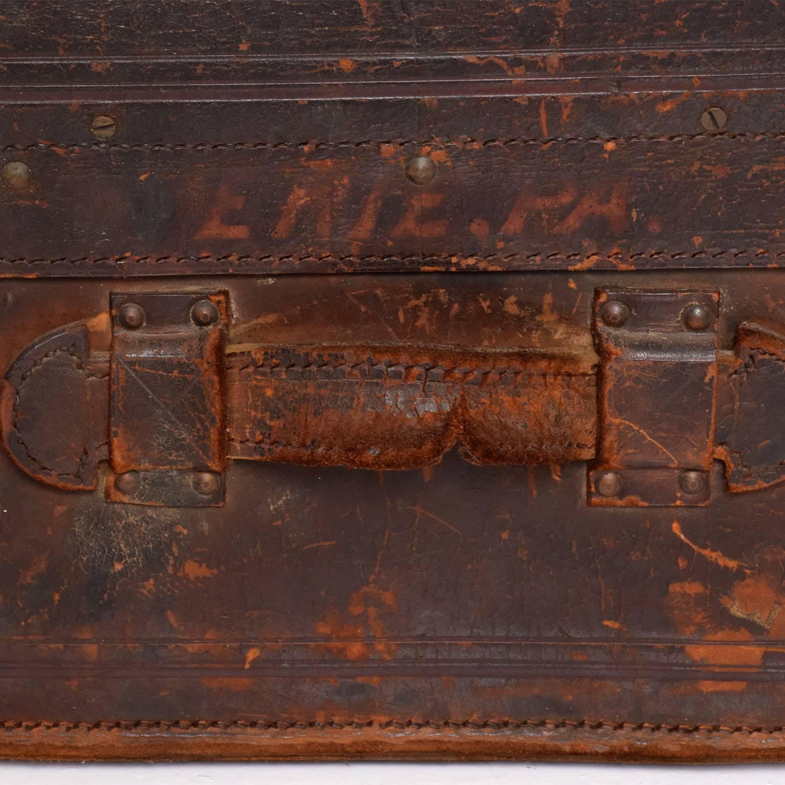 An antique travel leather trunk.
Beautiful vintage patina.
No lock present. Unrestored.
Dimensions: 16" H x 14"mD x 26" W, inside 7 1/2" H x 24 1/4" W x 13" D.
