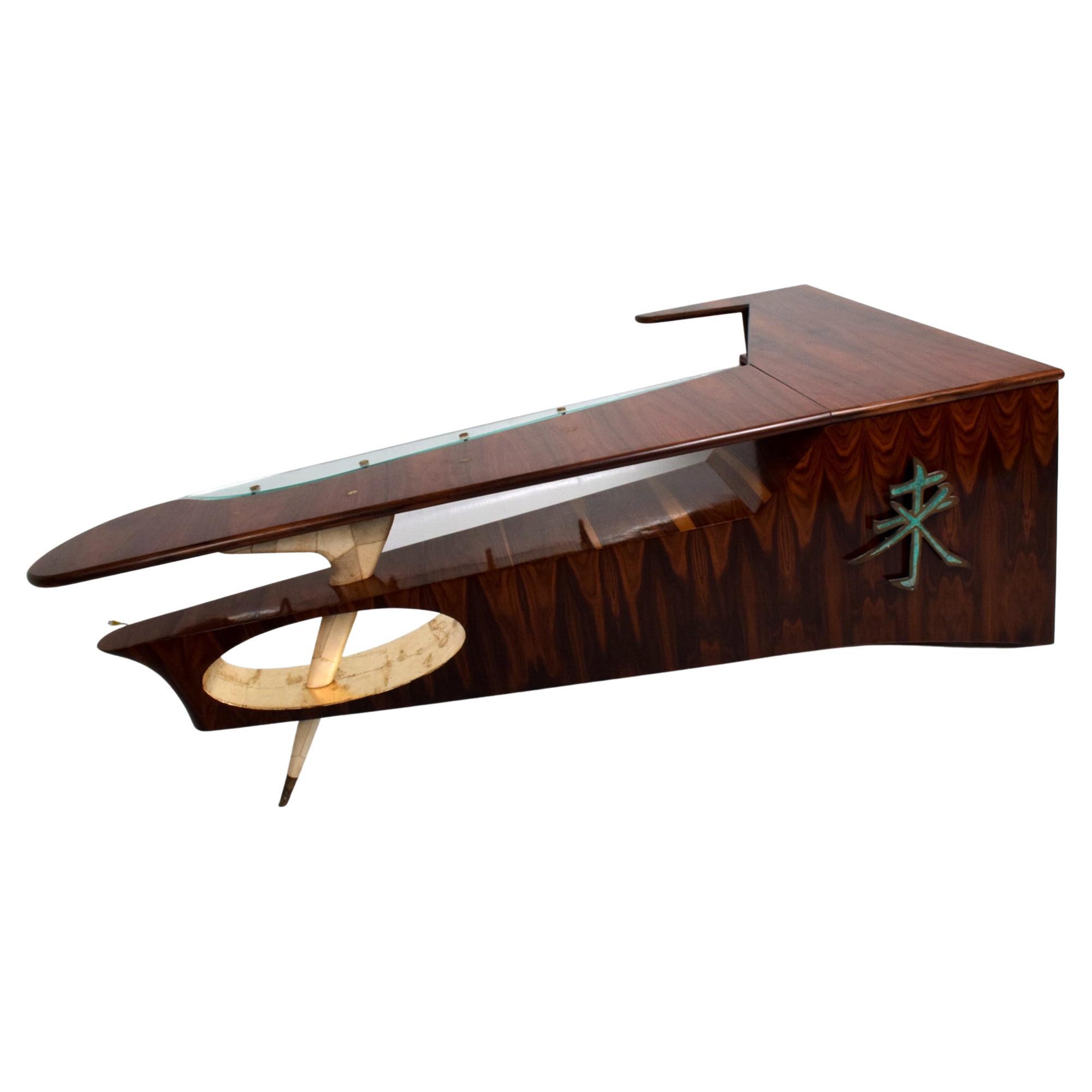 Custom Sculptural Desk Dry Bar in Rosewood and Parchment Bronze applications designed by FRANK KYLE.
Made Mexico circa 1950s.
Malachite hardware by PEPE MENDOZA foundry marks present.
Front receiving is supported by a single angled tapered leg. Leg