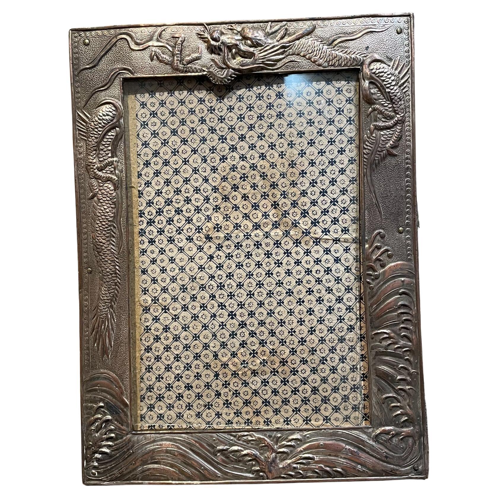 
1940s Antique Silver Nickel Photo Picture Frame
Stand up kick plate
Embellished Border design dragon serpent motif
7H x 5.25W .25D inches
Original Vintage Preowned Condition.
Refer to images.