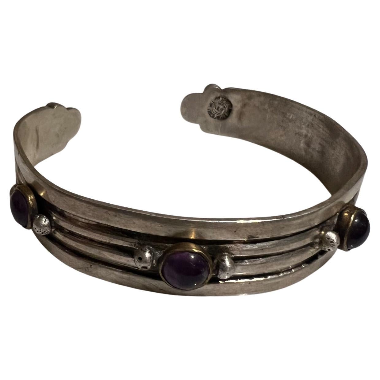 Rare Taxco Mexican Modern early Silver Artisan jewelry by famed William Spratling
Sterling silver slender cuff bracelet Jeweled Amethyst and brass
Maker Stamped William Spratling. Made in Mexico circa 1940s
Original vintage condition