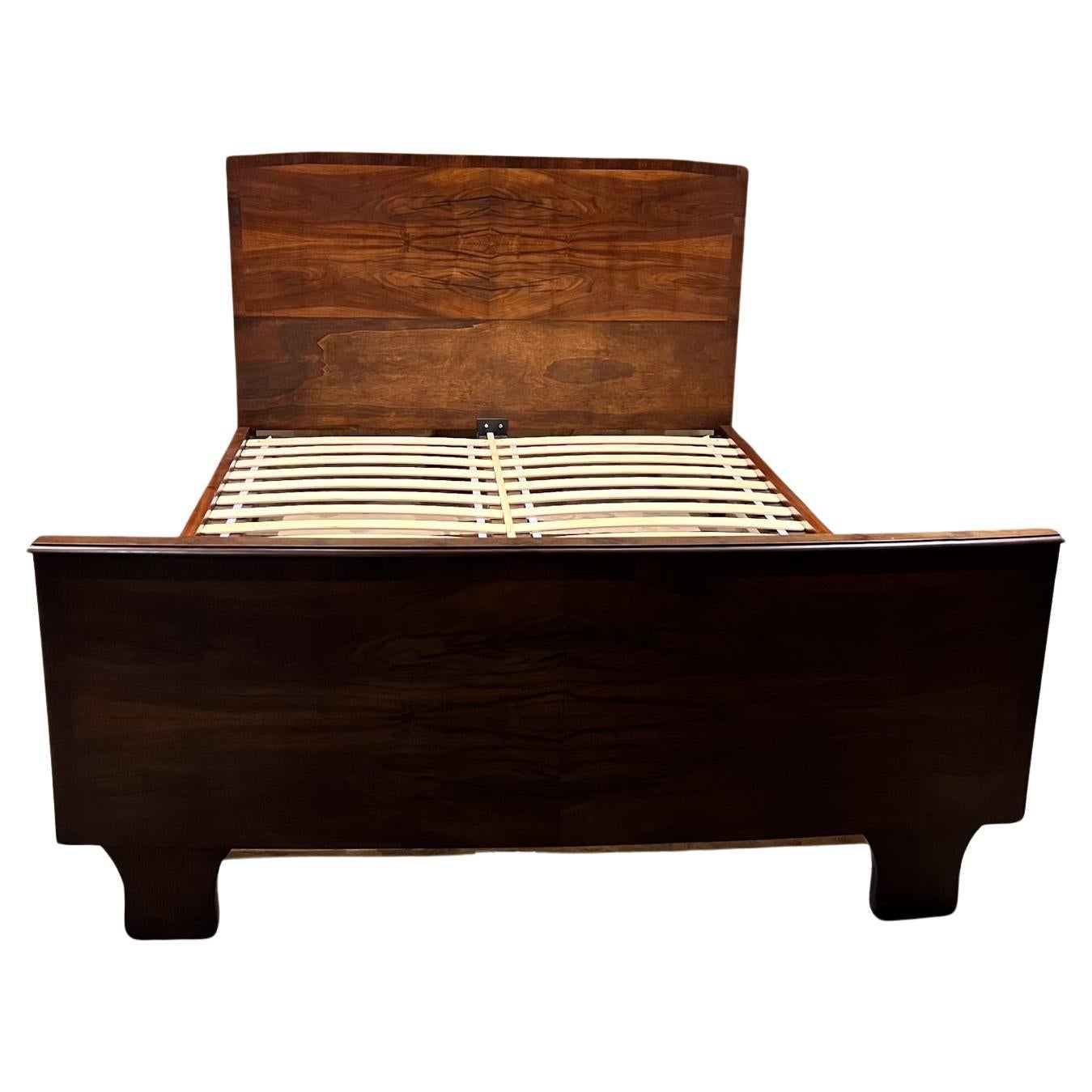 For your consideration, 1950s Sculptural Italian Custom Queen Bed Exotic Wood 
Osvaldo Borsani Italy
Sculptural Legs with footboard of book matched veneer.
Dimensions: 48.25 h x 64.5 w x 87 d Mattress area 81.25 x 61 
Mattress at 13 h
Made in Italy