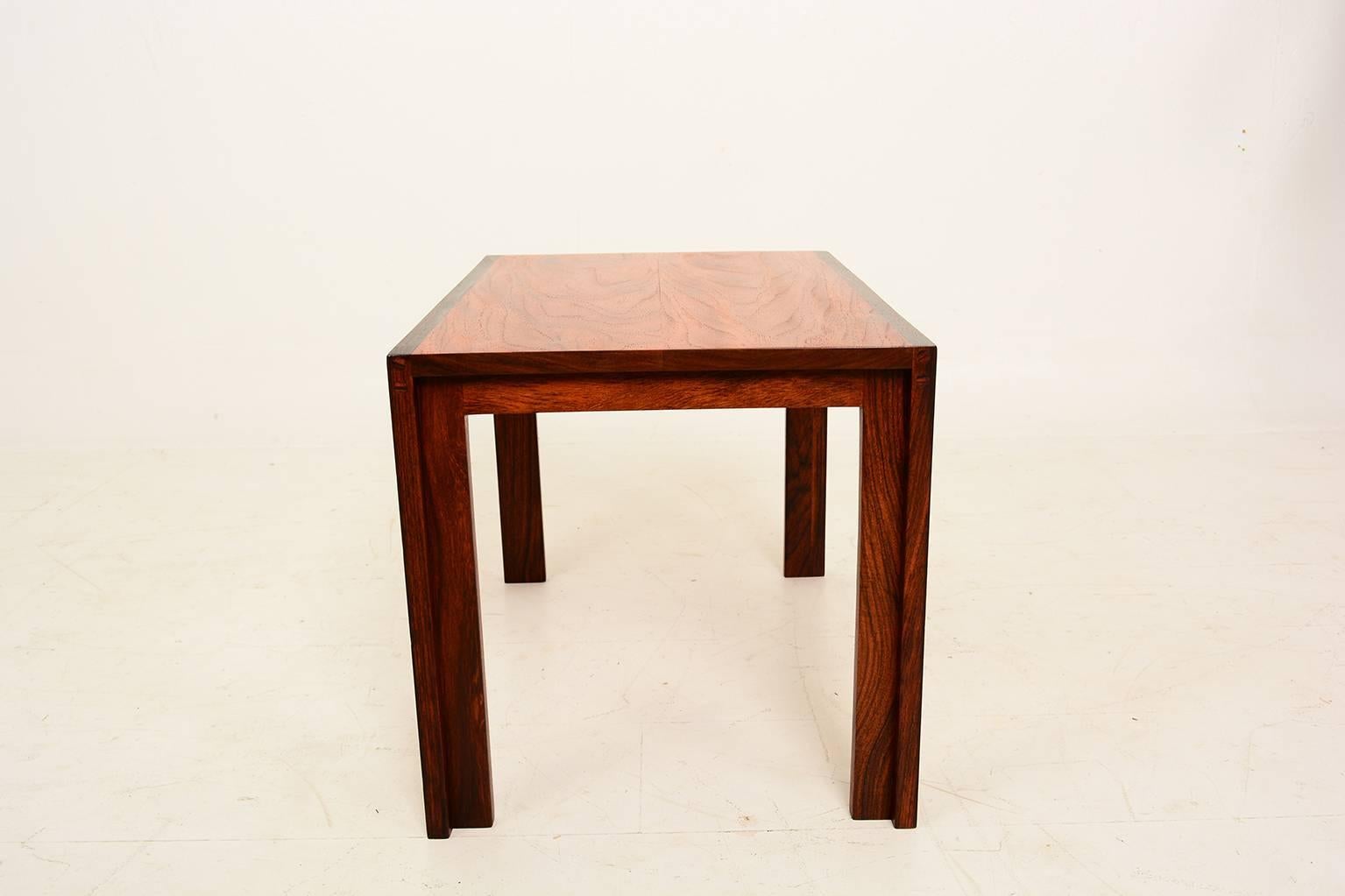 We are pleased offer for your consideration a solid wood side table. Beautiful grain.
the side and legs are solid rosewood. The top appears to be mahogany.

No markings from the maker, based on the quality, it seems to be an studio designer piece.