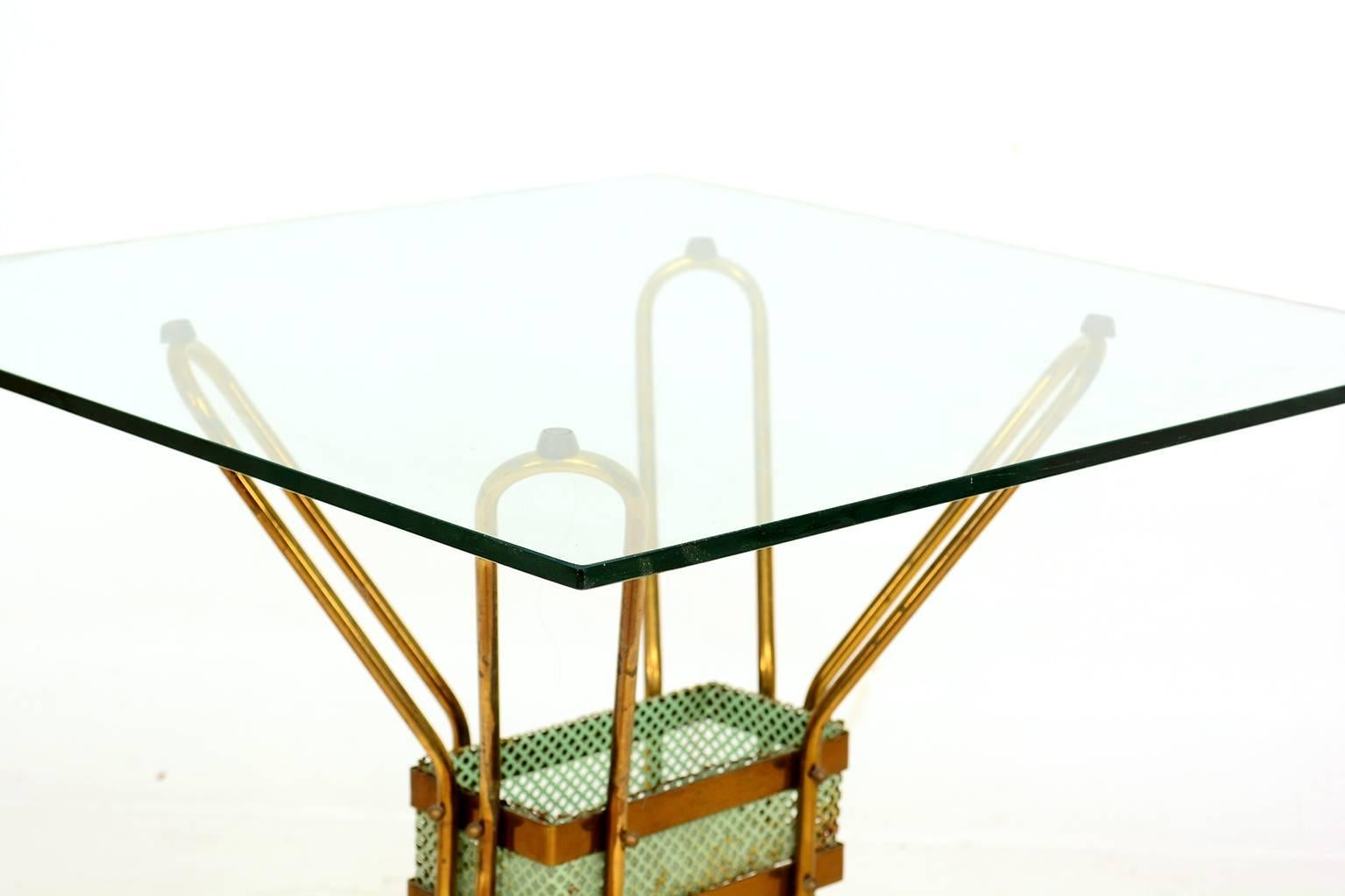 For your consideration a vintage Italian side table in brass and glass top. 

The sculptural legs are attached to a metal frame with brass accents with brass screws and ball nuts. 

The glass rest in top four rubbers caps. 

Beautiful