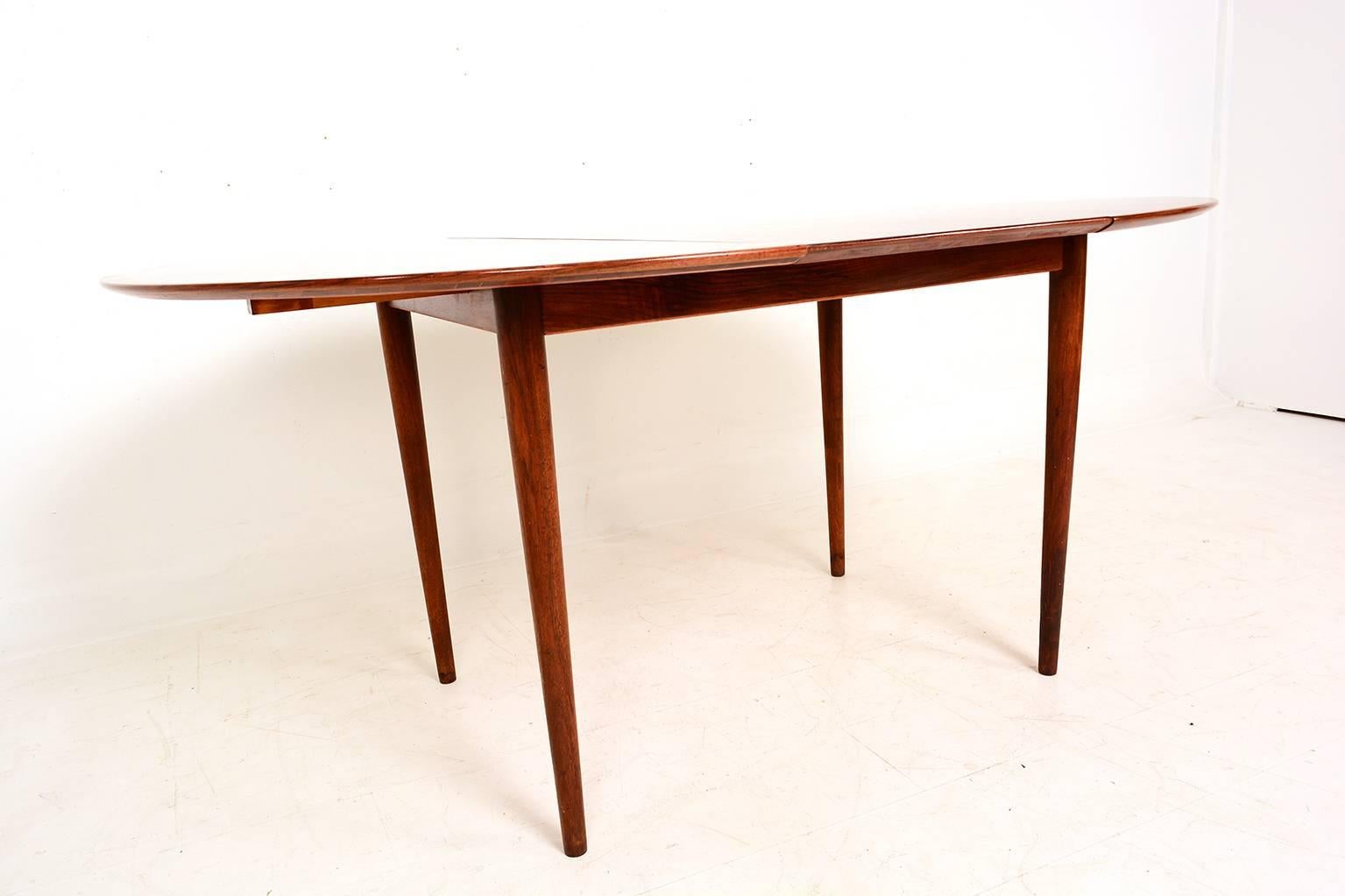 For your consideration a vintage dining table designed by Kurt Ostervig. 

Round table seats four can be extended to seat six.

Legs can be removed for safe an easy shipping. 

Closed is 45 1/2 in Diameter, Fully extended is 64 1/4