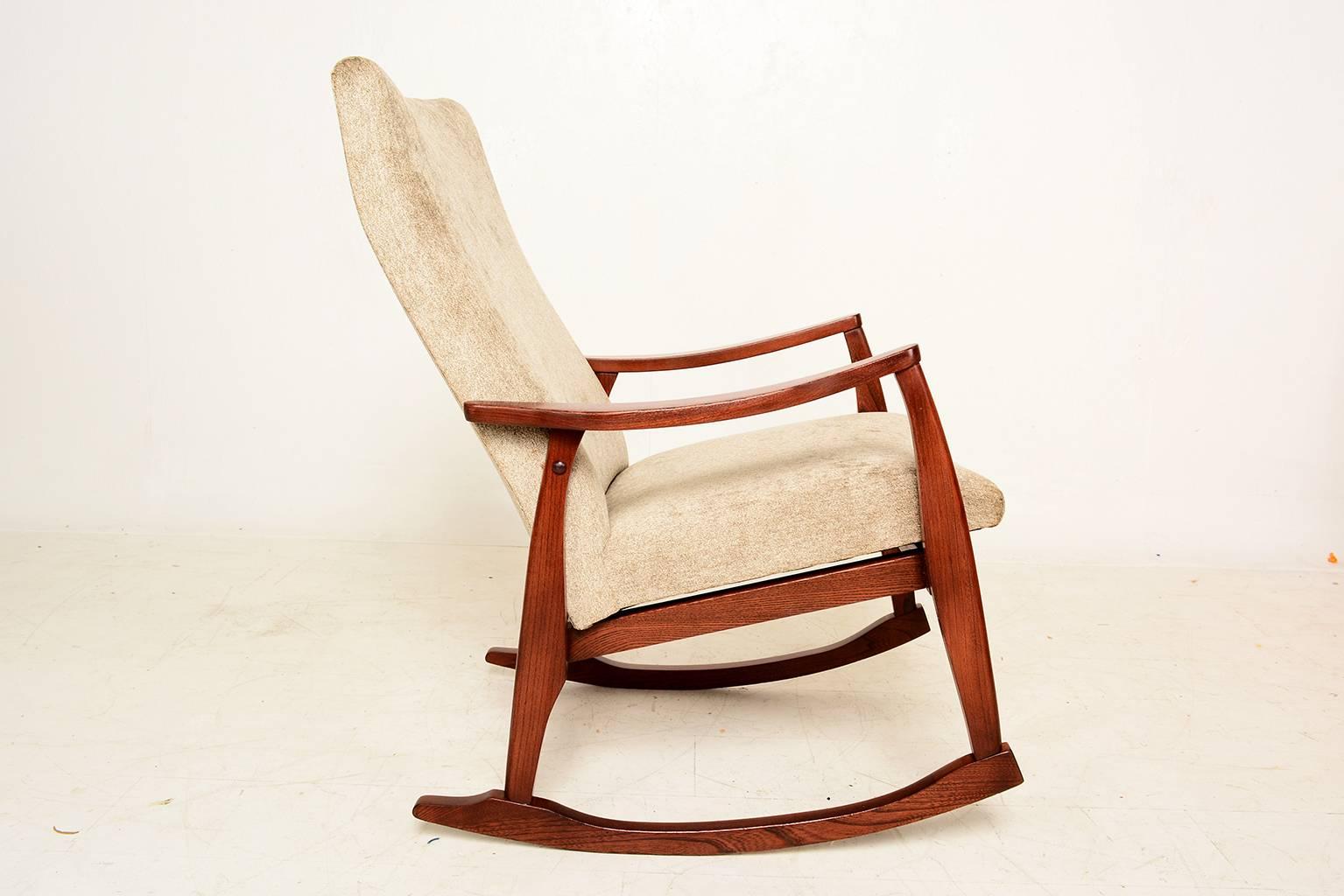 For your consideration a Mid-Century Modern rocker in soft warn grey fabric. 

Solid wood frame with sculptural lines finished in walnut tones. 

Unmarked, no information on the maker or designer. 

All joints are very firm and sturdy.