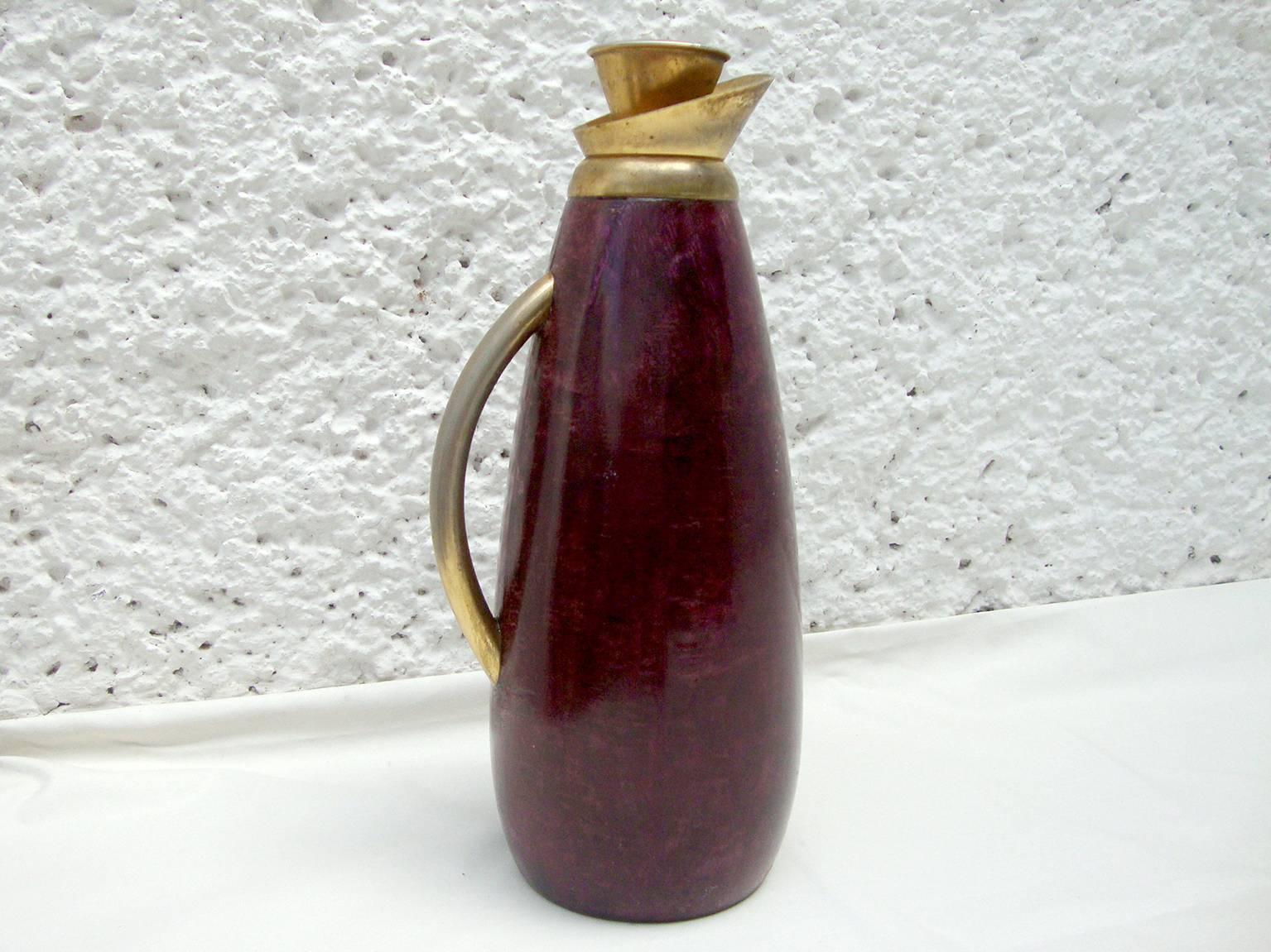 For your consideration a vintage Aldo Tura pitcher with red/wine color goatskin.

Handle and cork stopper in brass-plated metal. Some fading present due to use. 

Label from the maker underneath.
    