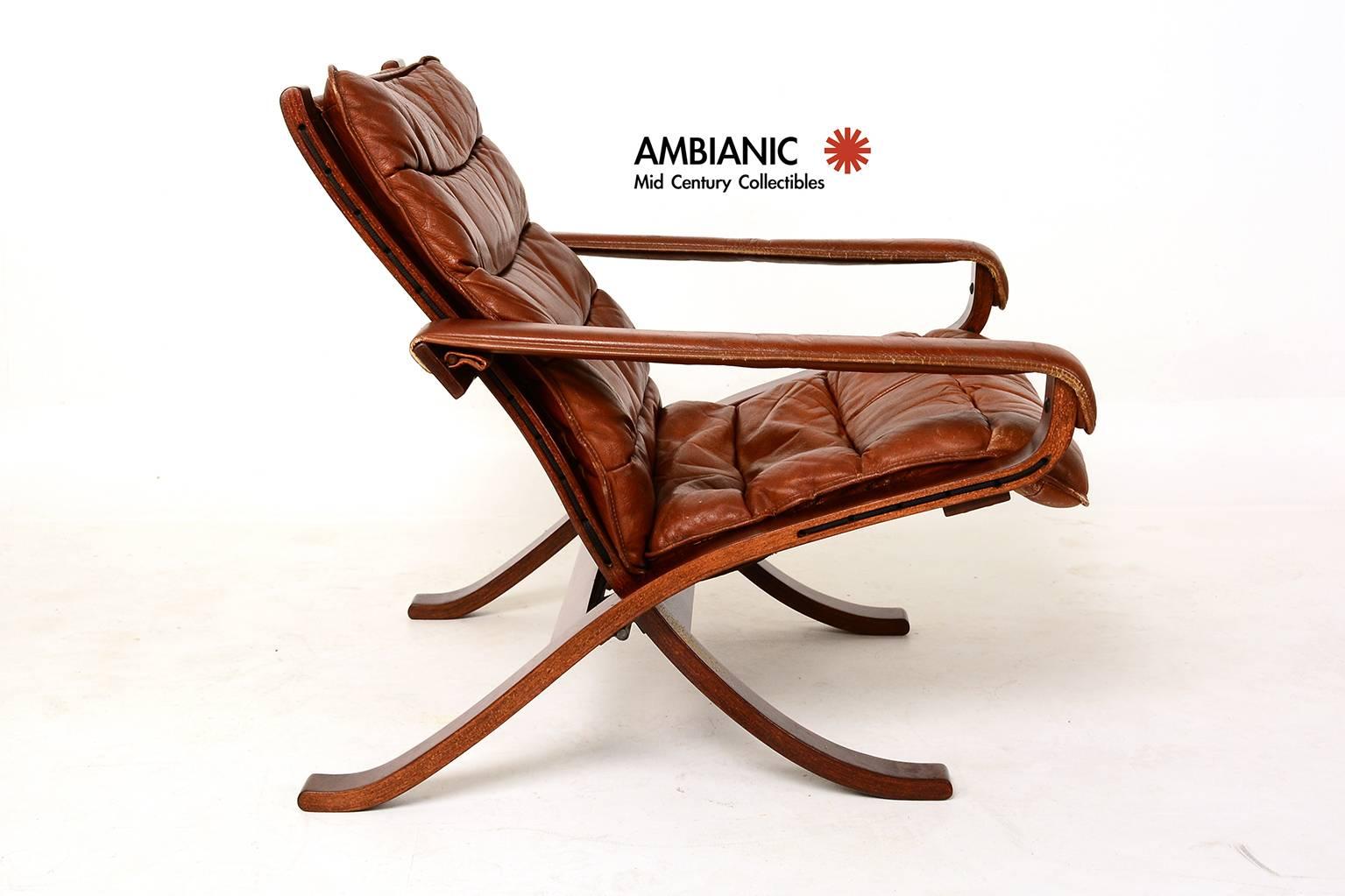 For your consideration a vintage chair by Westnofa. Very rare folding model. Bent plywood wood frame finished in walnut tones with original leather cushions and armrest. The brown canvas is original with new cord. Brown leather cushion with original