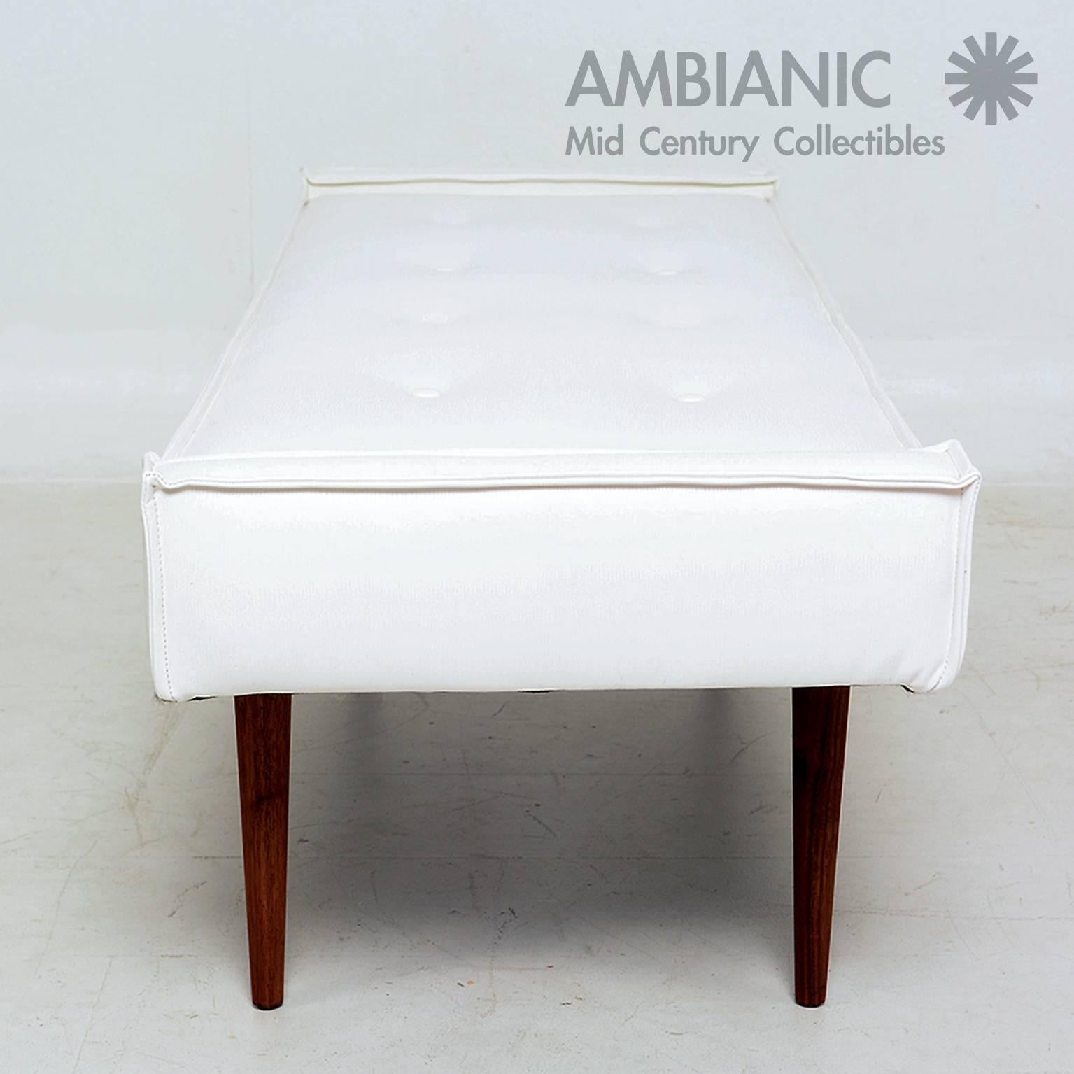 For your consideration, a Mid-Century Modern bench with new faux leather upholstery in white with lizard skin pattern. 

The legs have a tapered shape with an octagon shape. 

They can be removed for safe and easy shipping. 
Top cushion has