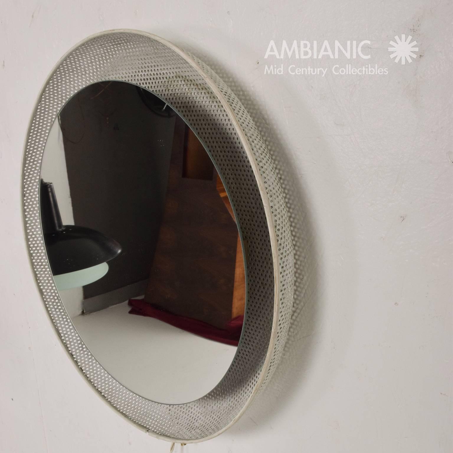 For your consideration a vintage wall mirror with built in light. It is recommended that the light be hardwired, however it has an electric cord with a US plug. Perforated metal is painted in white. 17 1/4