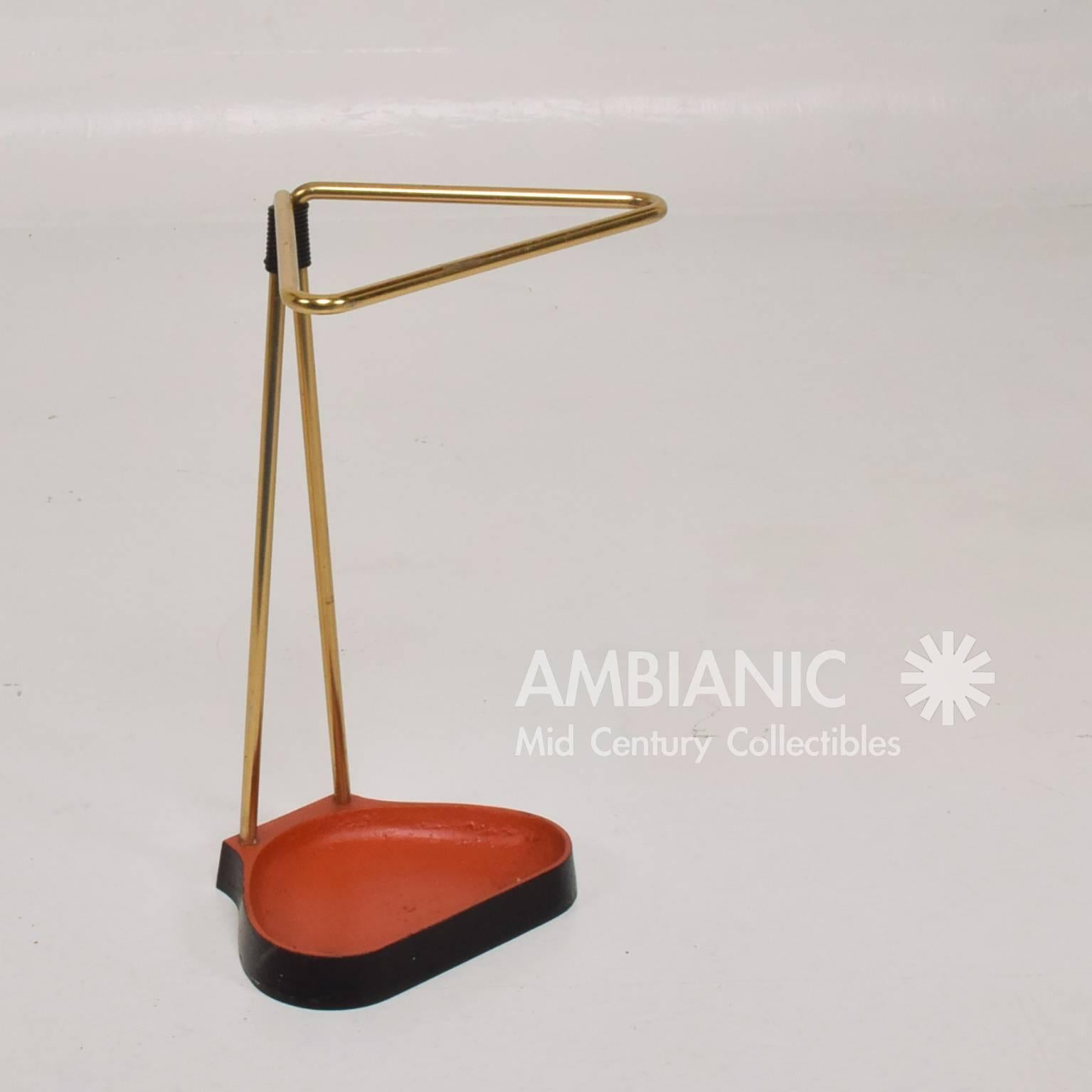 For your consideration a vintage umbrella or cane holder. Made in Europe, circa 1950s. Cast iron base painted in black and red with sculptural body in brass. There is numbers stamped underneath the cast iron piece, however there is no information
