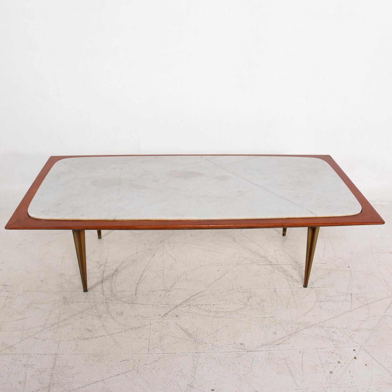 We are pleased to offer you a stunning sculptural coffee table attributed to Eugenio Escudero. 
Solid brass legs in the style of Gio Ponti and marble top.
Made in Mexico City in the 1950s.
Dimensions: H 17 in. x W 59 in. x D 30 in.

 