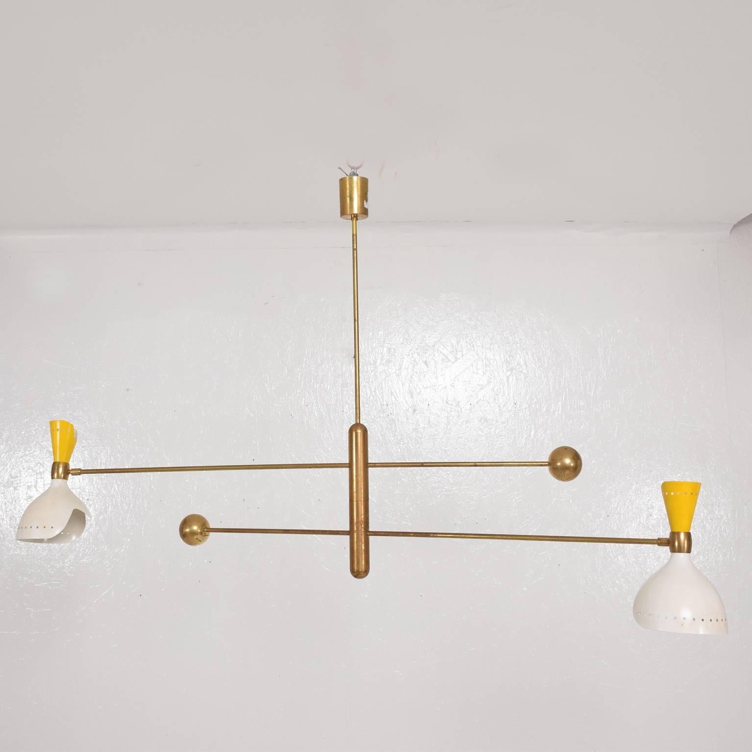 For your consideration a vintage chandelier in the style of Stilnovo. Beautiful mobile sculptural configuration.
Brass body with double shades in yellow and off white color.
Arms are fully adjustable.
Dimensions: 32