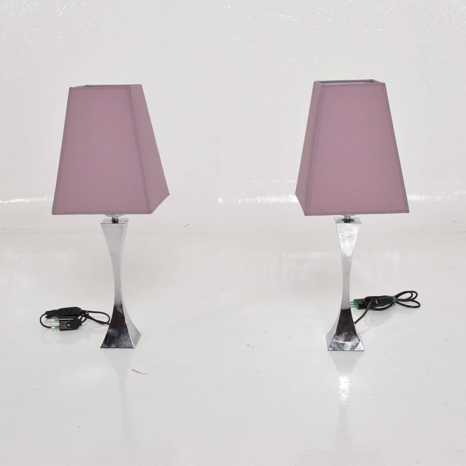 For your consideration a pair of Italian table lamps in chrome plated steel. 
Made in Italy, circa 1960s by Tonello & Montagna. 
Original shades.
Dimensions: 14" H x 3" x 3" , 22" H with shade. 
Shade 10" H x 7 3/4 x