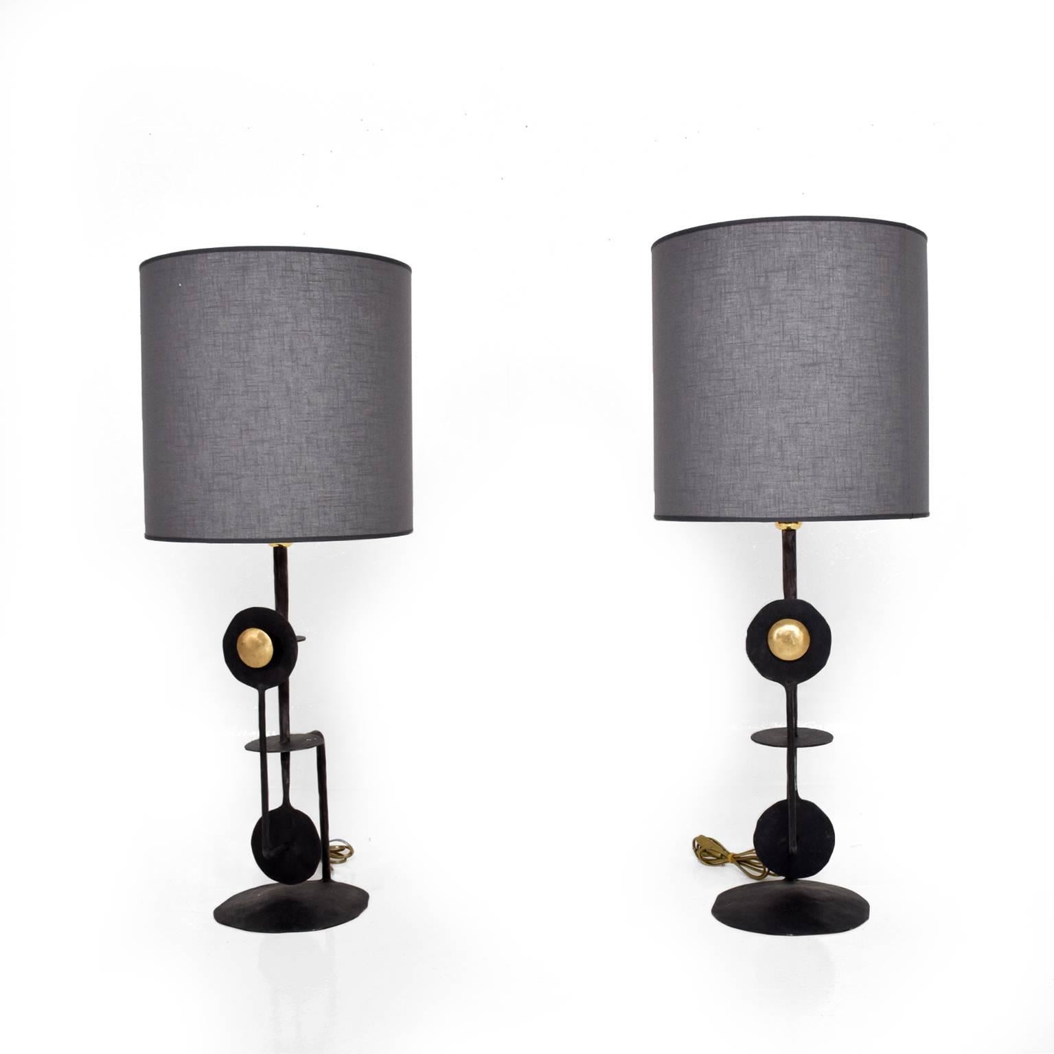 For your consideration a pair of brutalist Italian table lamps.
Constructed with forged iron painted in black with brass accent.
Italy, circa 1980s.
Dimensions: 25" height x 8" in diameter. Shade (inquiry).