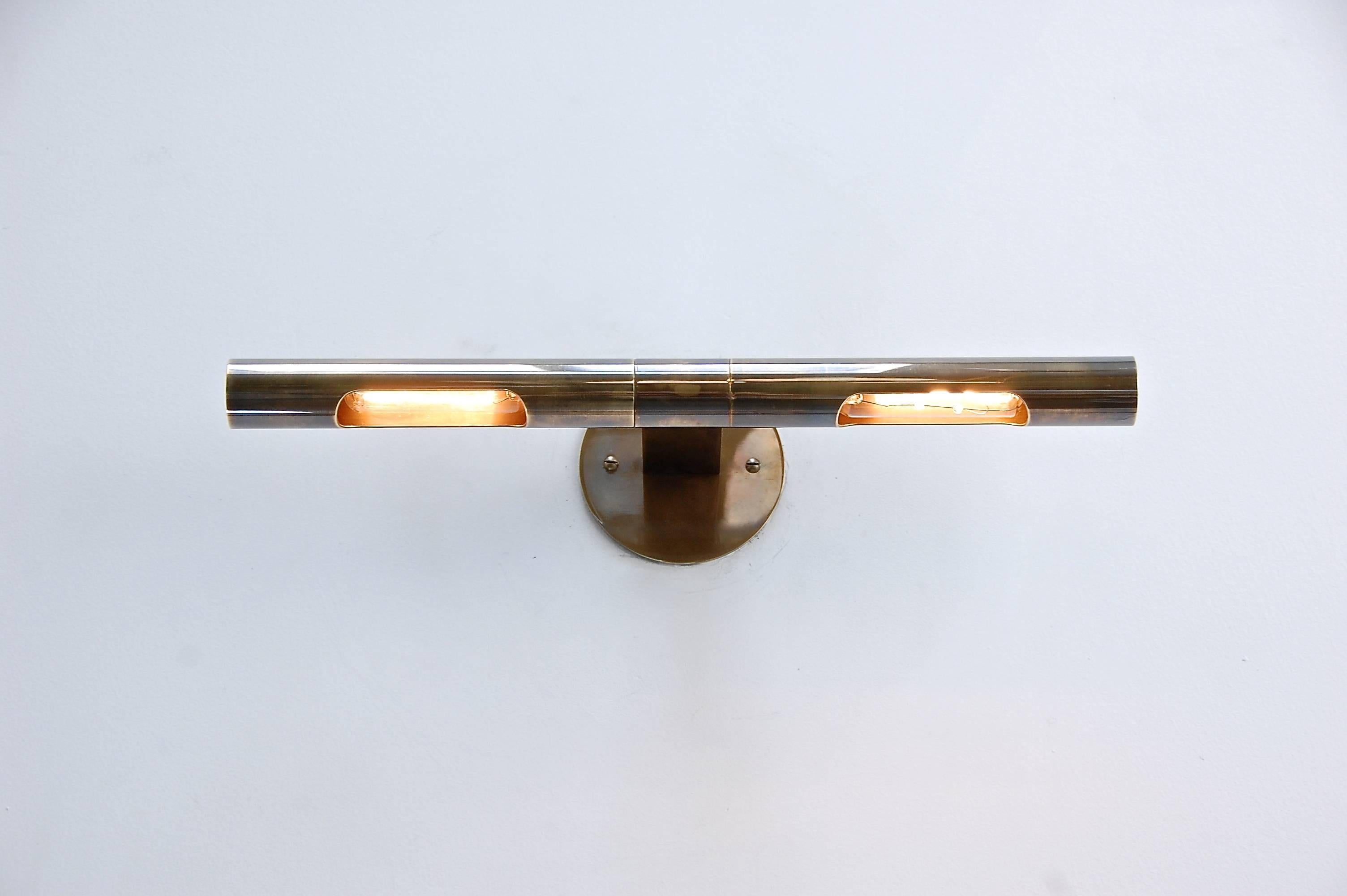 LUart Directional Sconce PB is a superbly crafted linear wall sconce designed by Lumfardo Luminaires to feature artwork and/or objets d’art. Each shade is independent and can be directed individually. Patina un-lacquered brass, different finishes
