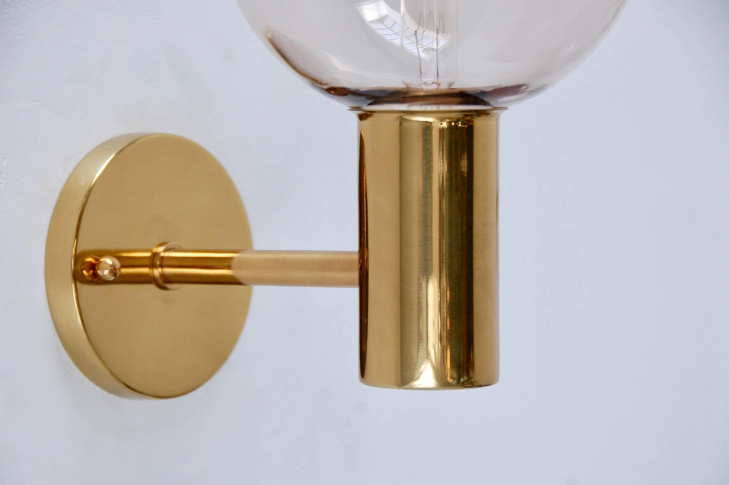 2' Classic modern Swedish/Scandinavian brass and blown rose glass sconces from the period/1960s. Single E12 candelabra based socket. Wired for use in the US. Partially restored. Measures: Back plate 4” with 2 ¾” centre to centre mounting holes.