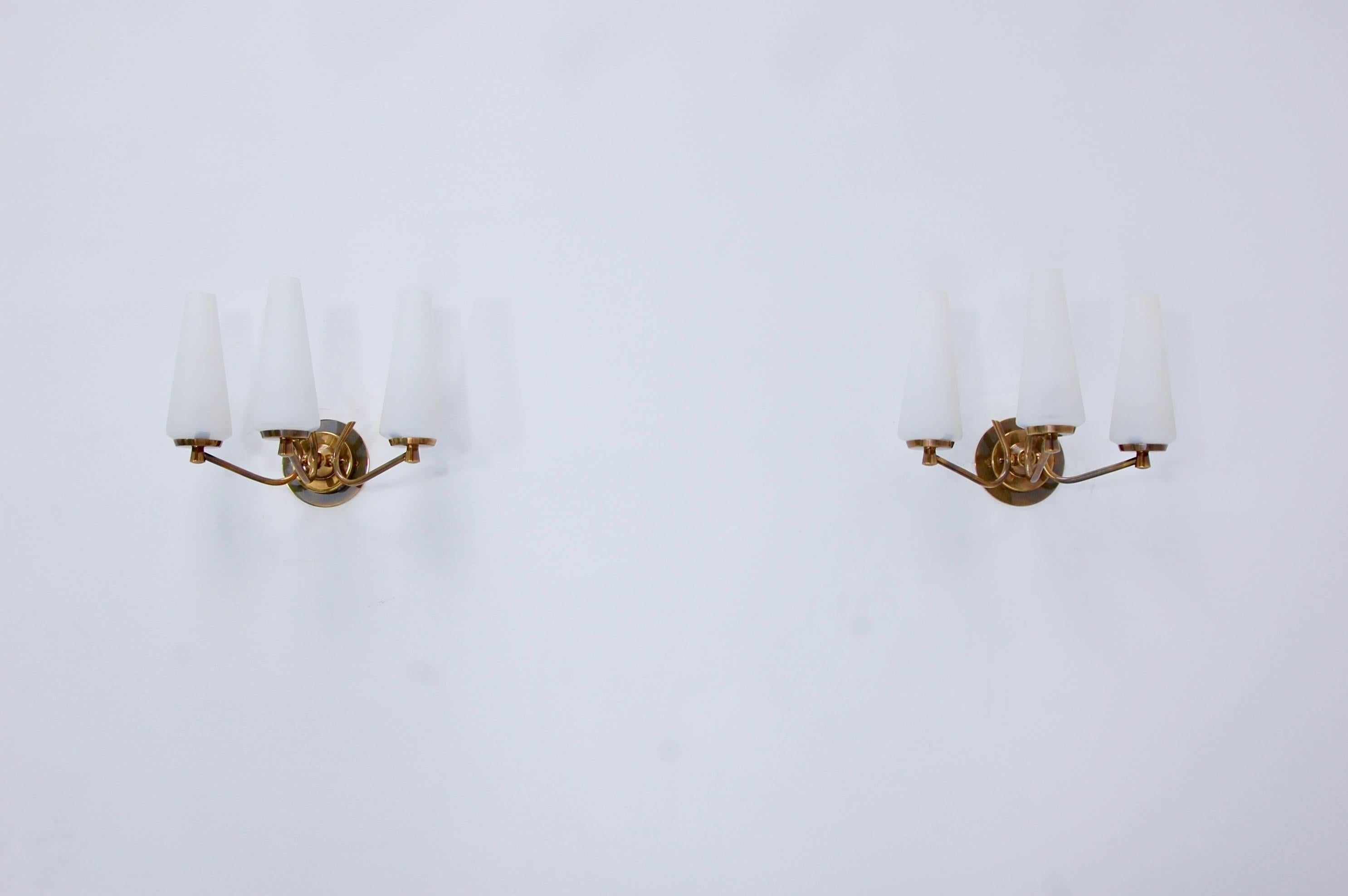 A pair of Classic brass and three glass shades 1950s sconces from Italy. Fully restored, patina lacquered brass finish with a single E12 based socket per shade. Maximum wattage 40-60 watts per socket. Back plate has 2 ¾” centre to centre mounting