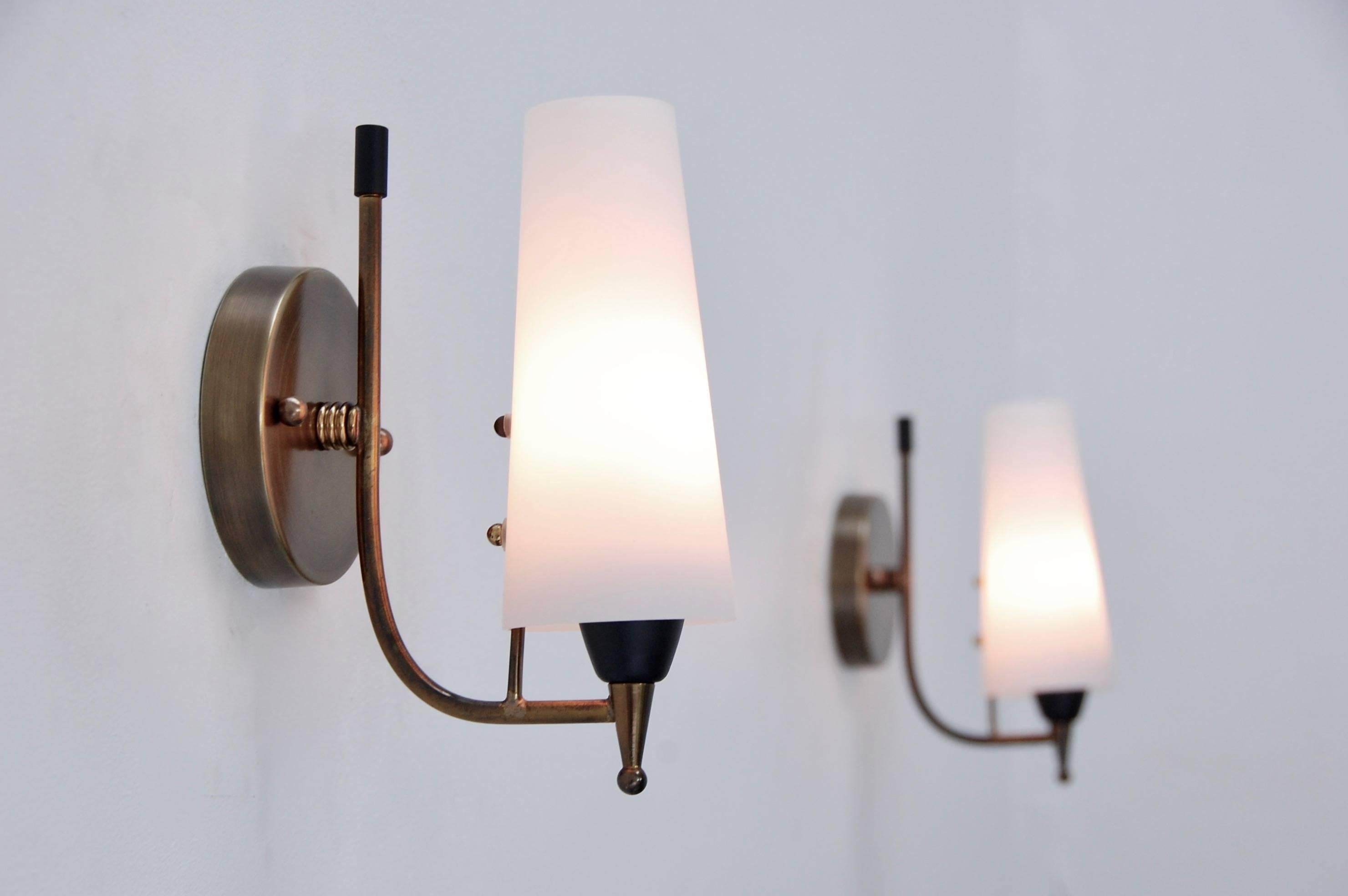 A pair of Classic 1950s brass and glass conical shade sconces from Italy. Fully restored, patina lacquered brass finish with a single E12 based socket per sconce. Maximum wattage 40-60 watts per socket. Back plate has 2 ¾” centre to centre mounting