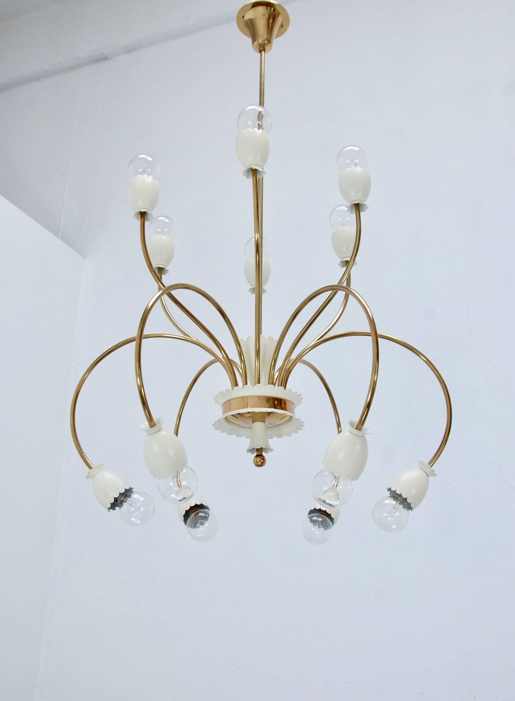 Of the period large brass Italian 1950s twelve-light chandelier botanical chandelier. Fully restored with E12 candelabra based sockets, wired for the US. Patina lacquered brass finish and painted aluminum decorative cups. 

Overall drop: