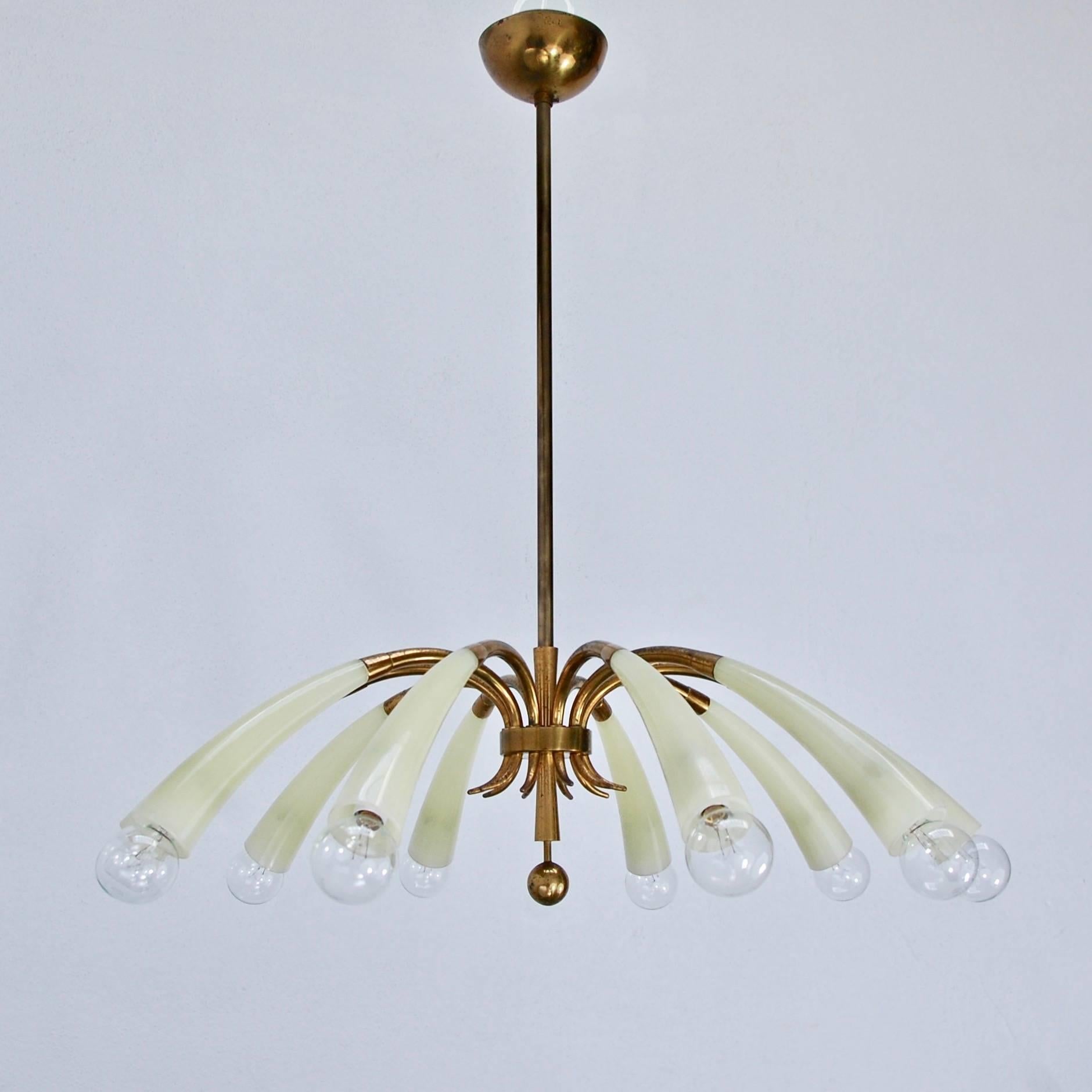 Stunning ten-light fluted glass chandelier from 1960s, Italy. Beautifully naturally aged brass and elegant fluted arms. 
OAD: 28.5” with light bulbs
Diameter: 27”
Chandelier Height: 9”.
  