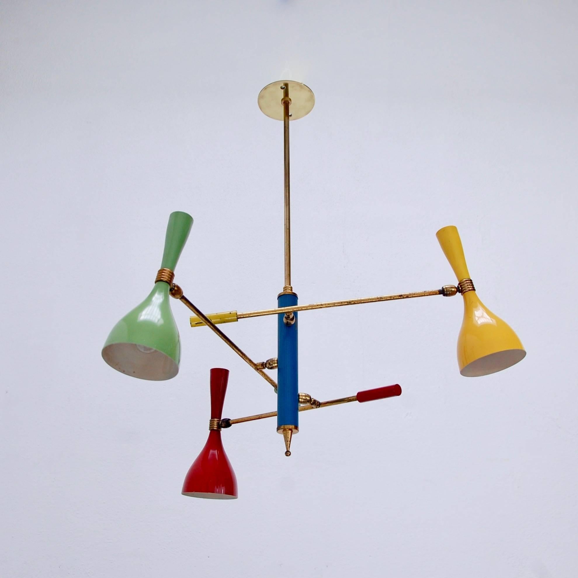 Classic of the period midcentury Italian multicolored three-shade chandelier by Arredoluce, 1950s, Italy. Single candelabra E12 based socket per articulating shade. Original paint and finish.
Measures: Diameter 22”
Shade height 8.5”
OAD: