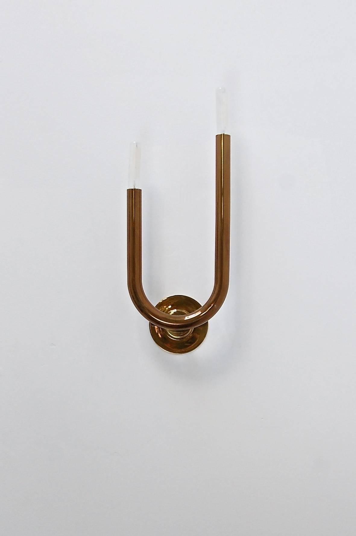 Superb and sleek modern LU Wall sconces by Lumfardo Luminaires lightly aged lacquered brass. Candelabra based sockets. Lightbulbs included. Priced as a pair. (left and right sconces)

Measurements are with bulbs.