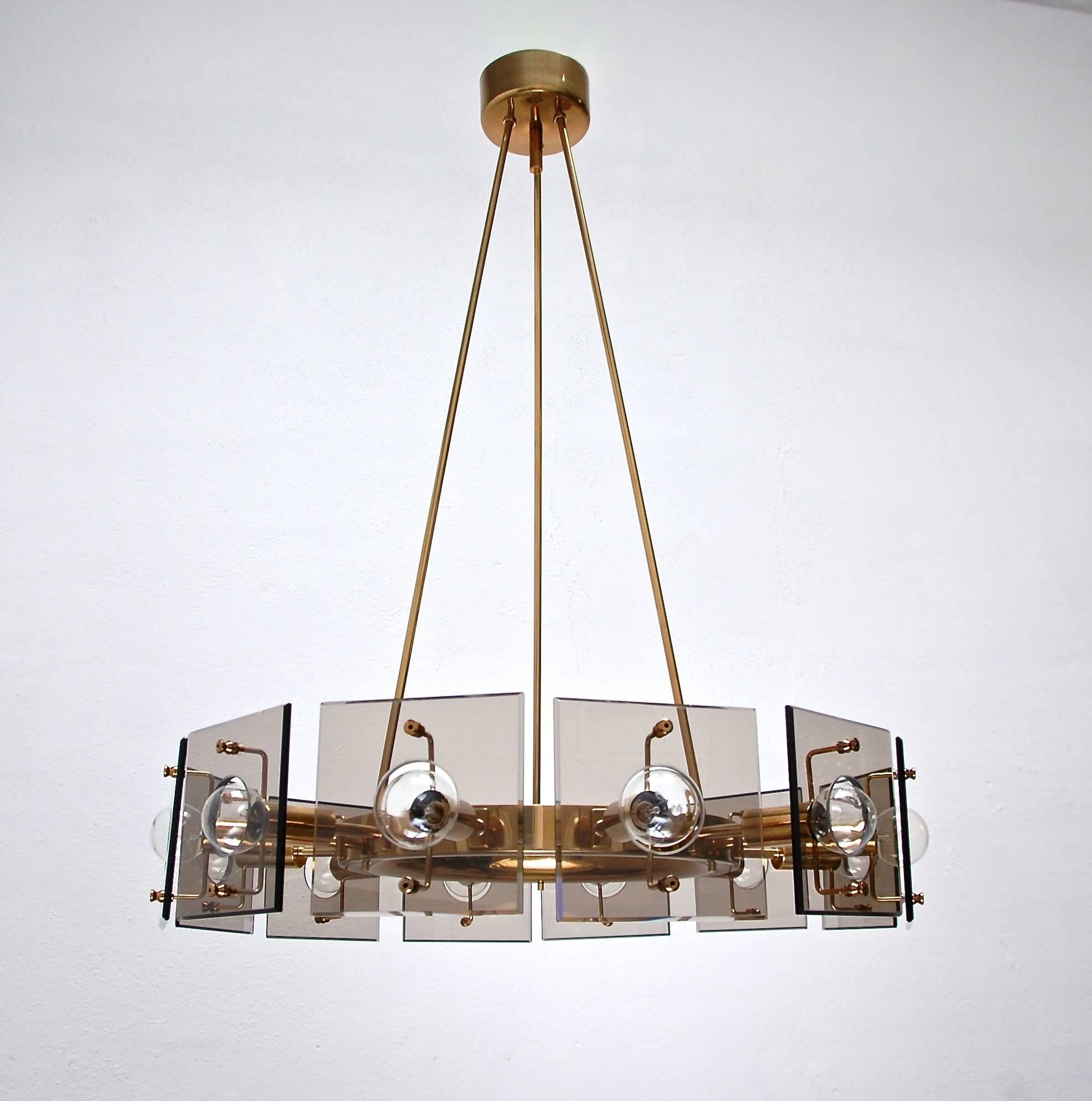Stunning brass and smoked glass Mid-Century chandelier from Italy by Arredoluce. Candelabra based E12 sockets, rewired for use in the US.