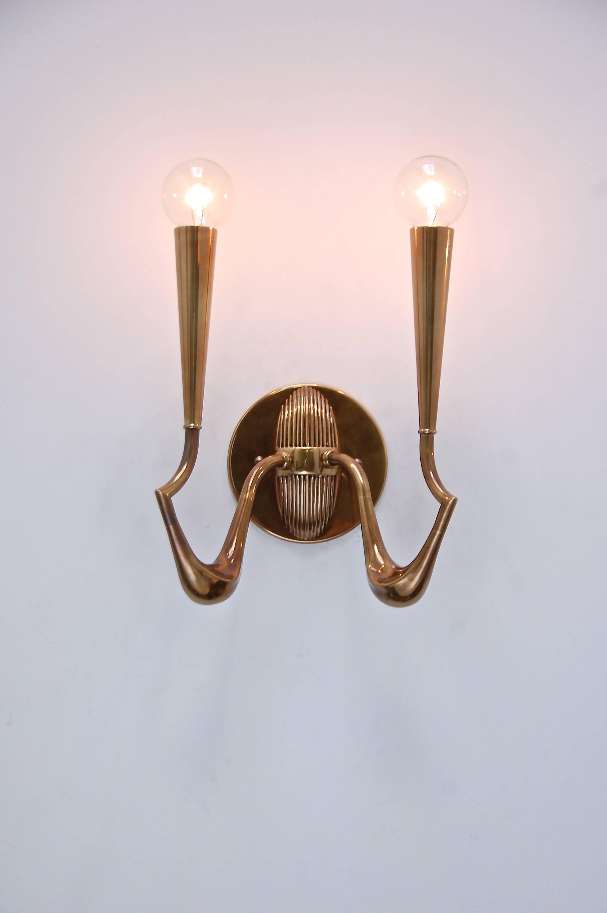 A pair of phenomenal solid brass Italian sconces reminiscent of Guglielmo Ulrich. They are rewired for use in the US. 
Candelabra based sockets.
Measurements are with featured light bulbs.