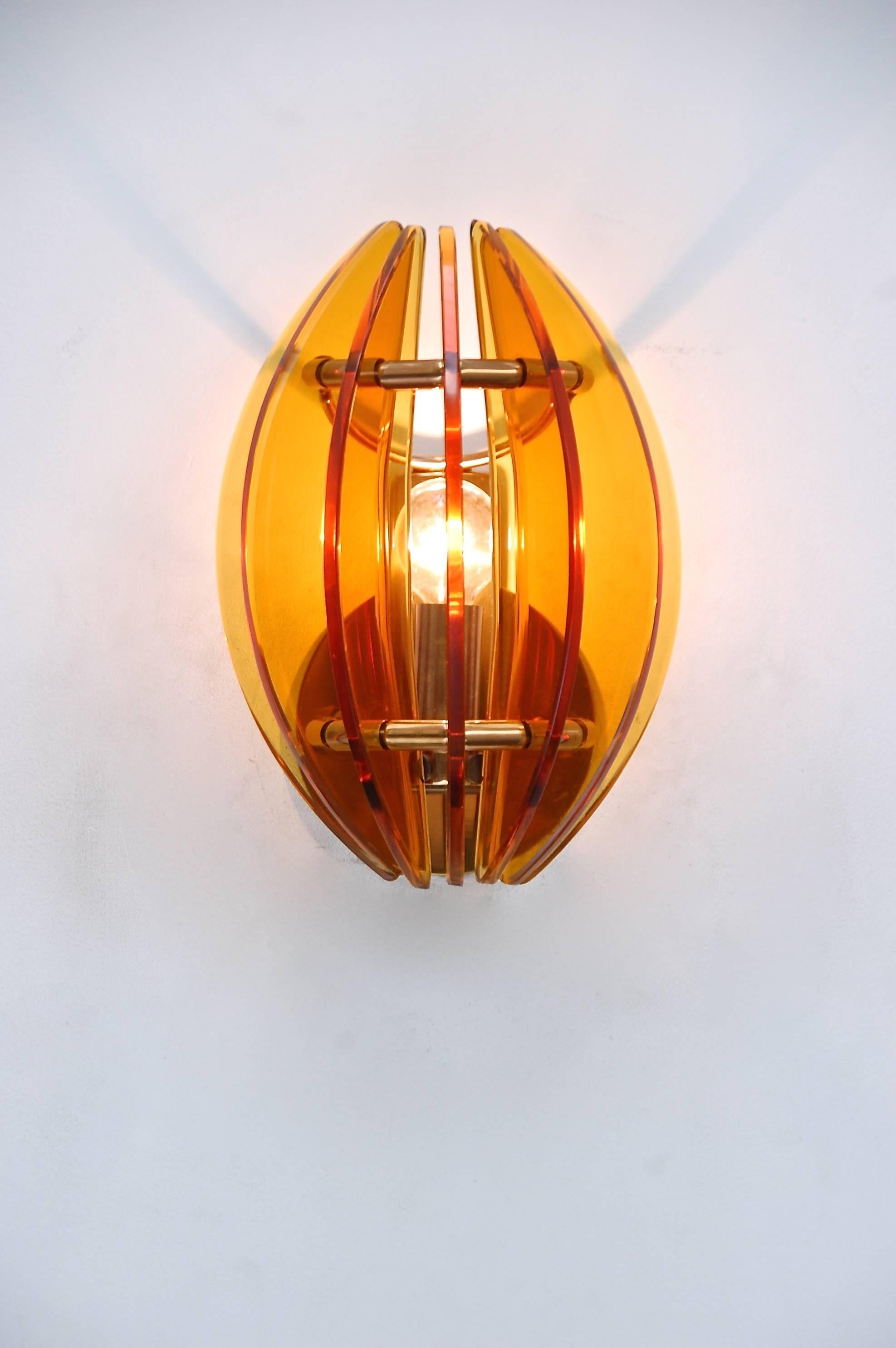 Beautiful and warm pair of Veca saffron crystal and brass sconces from Italy.