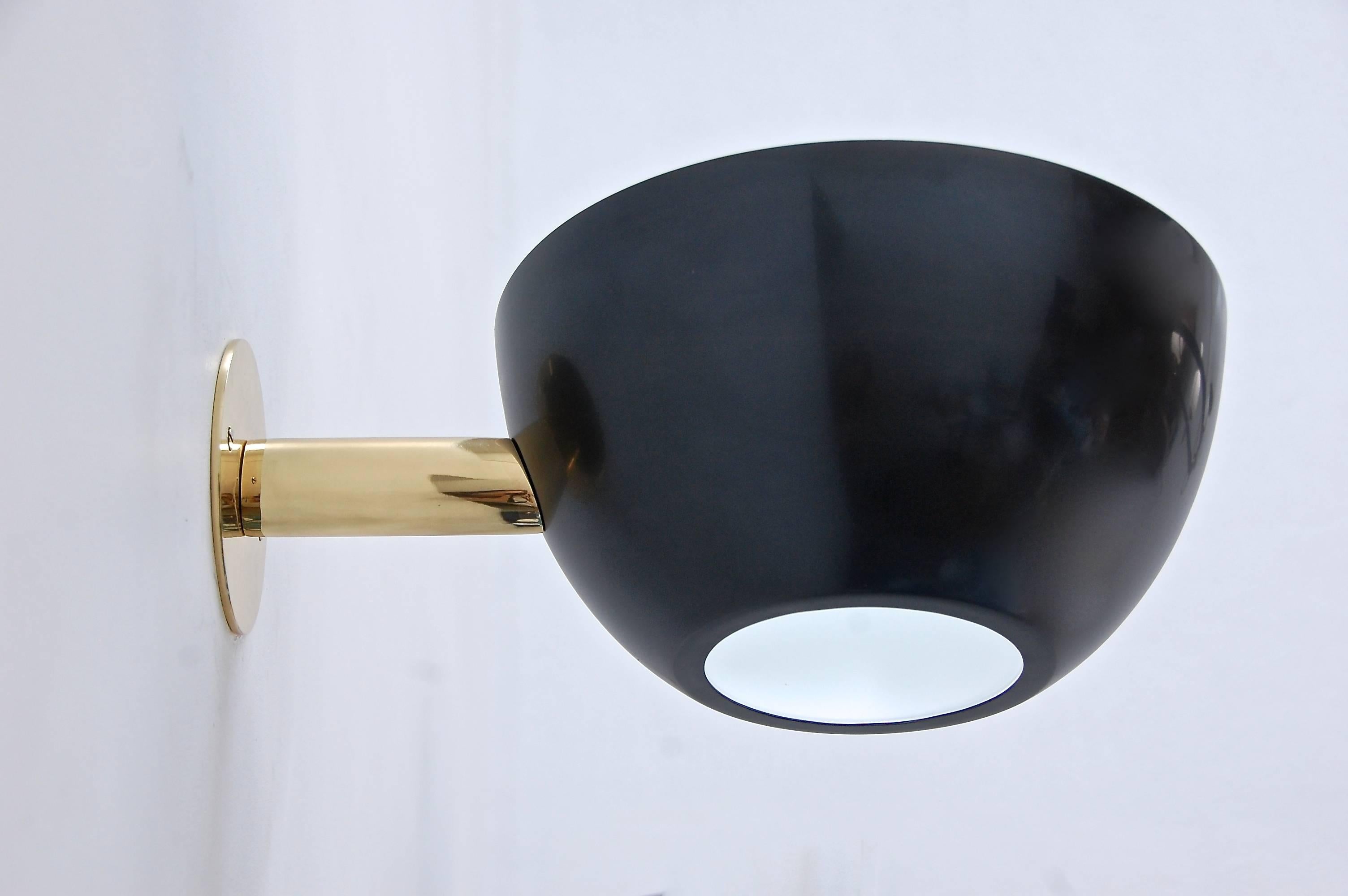 Inspired by 1950s Italian Design, this custom sconce is a companion piece to our large LUcrown chandelier. Single medium based socket. Dark patinated steel finish (shade) and lightly aged brass hardware. Priced individually. Multiples available to