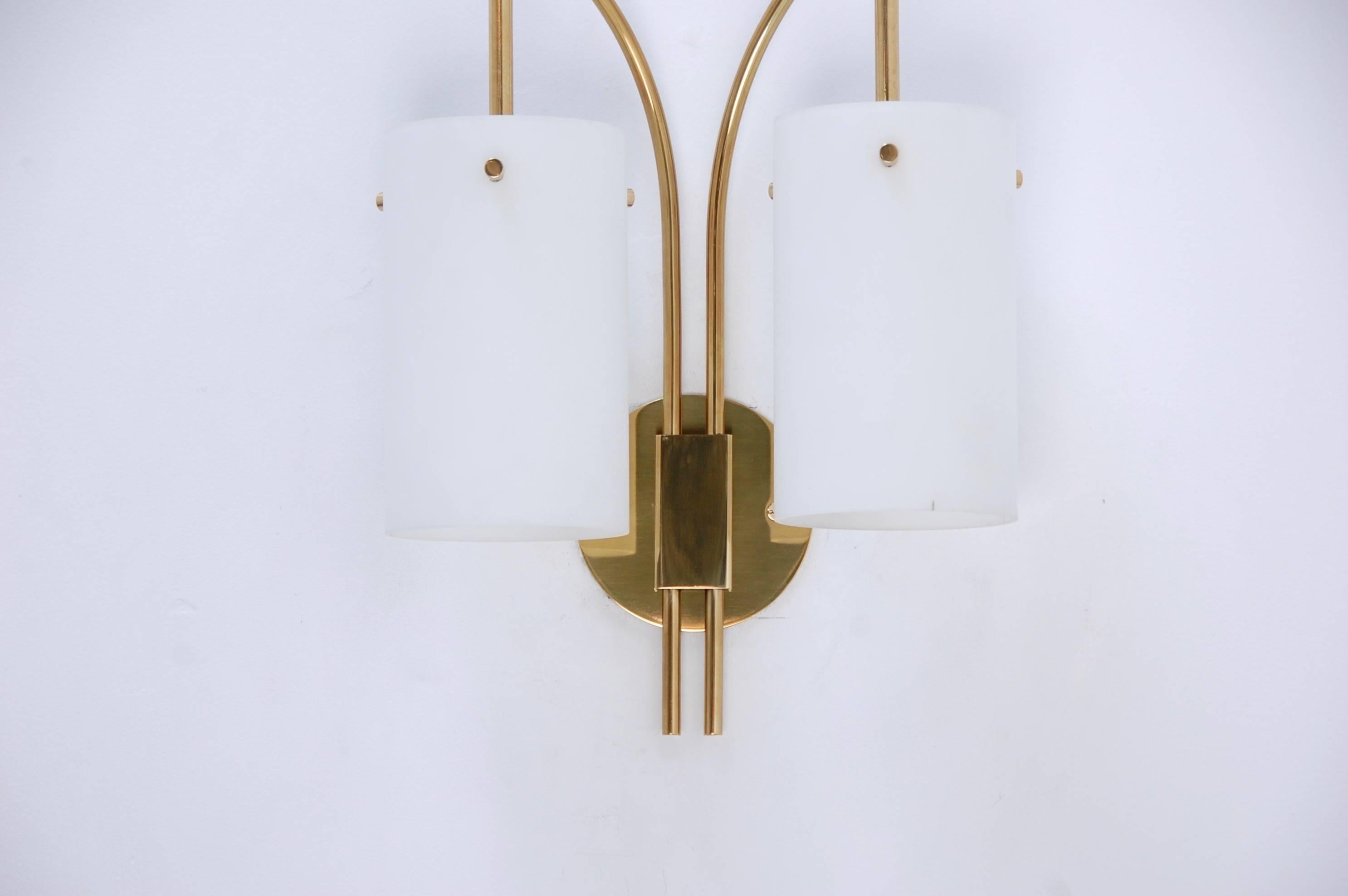 From the period 1950s Italian double shade cylinder sconce in glass and brass finish. Restored and rewired for use in the US. 4” backplate.